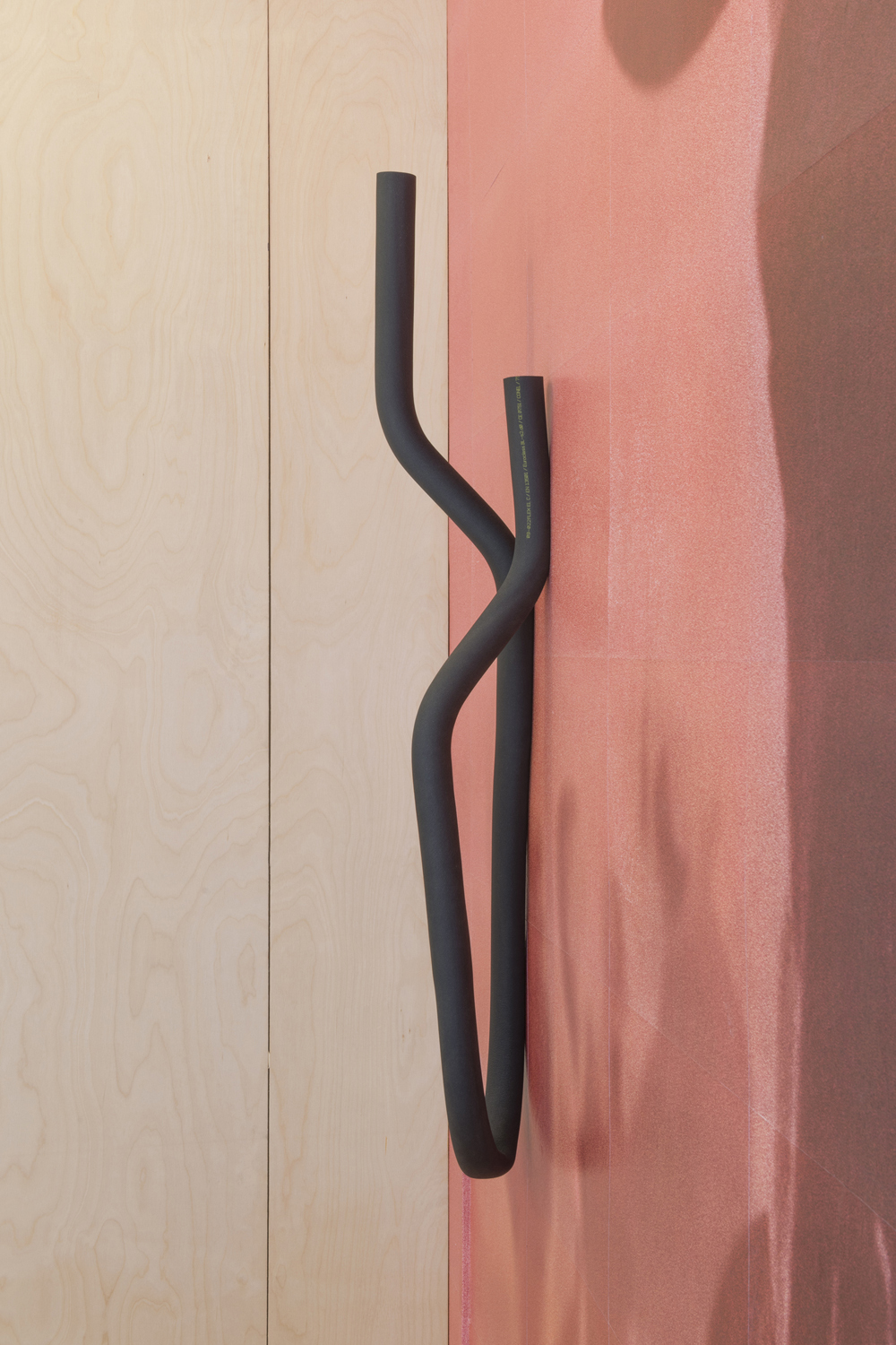 Natalia Domínguez, 'Mini K-FLEX FC0-10 VAR#4', black rubber shell, metal tubes, 2023 ; Atoq Wallpa Sua, 'No quiero volverme sombra, quiero ser luz y quedarme' (detail), wallpaper, 2023