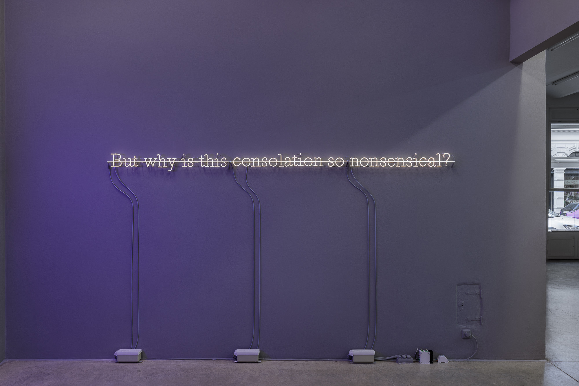 JOSEPH KOSUTH ‘C.S. II #12’, 1988 Text reads: But why is this consolation so nonsensical? Warm white neon mounted directly on the wall 17 x 325 cm © Joseph Kosuth / ARS, New York. Courtesy Christine König Galerie, Vienna.