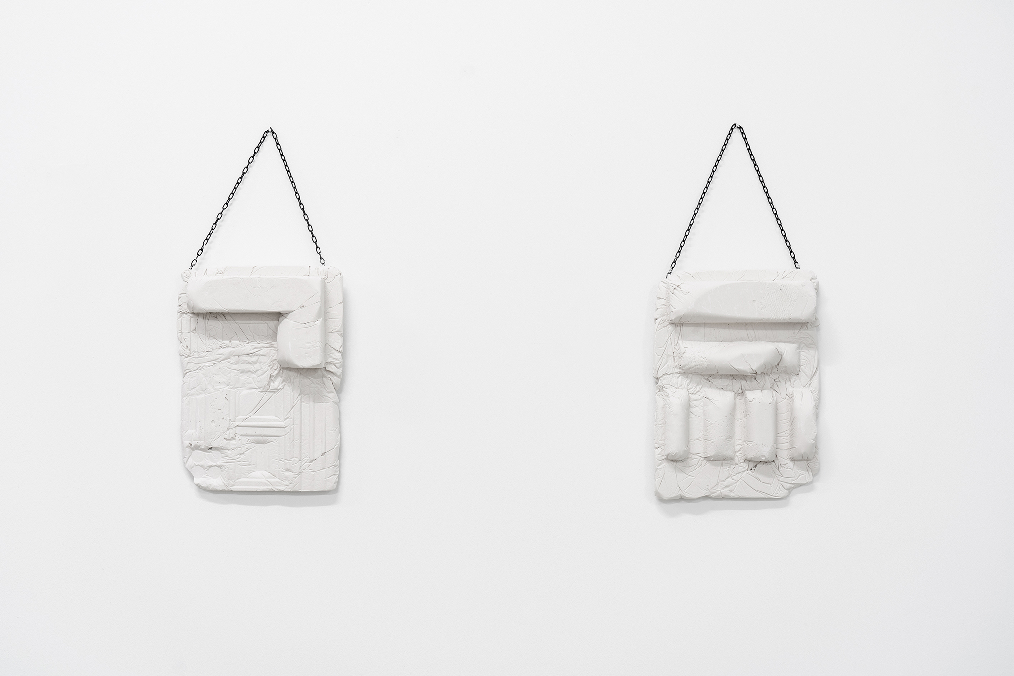 Anna Bochkova, „Algorithm of social housing N.4 and N.2“, plaster cast, gauze, metal chain, each 24x20x2 cm