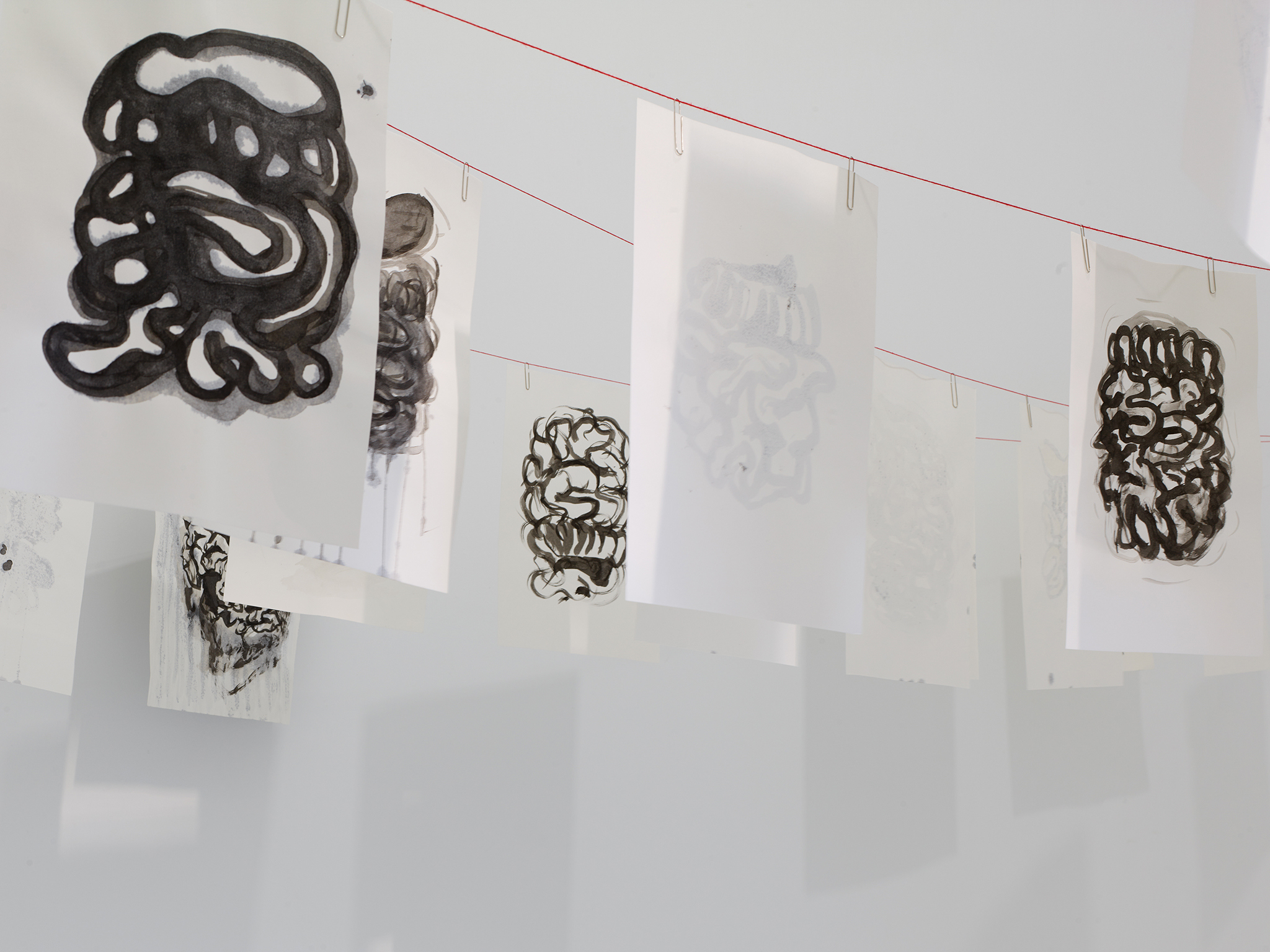 Installation view | ›The laundry room‹ | 47 drawings of ›Laundry‹ | red yarn, paper clips, Ink on paper| 30 x 42 cm| 2023