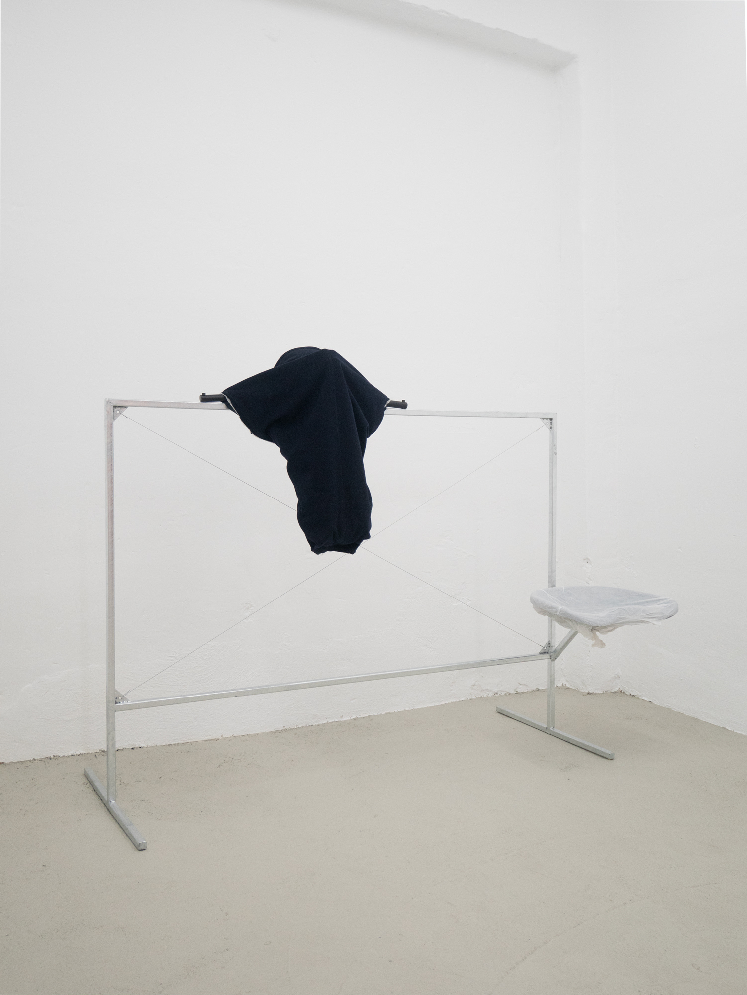 Clemens Tschurtschenthaler; socially detached figure; 2023; galvanized steel, loden coat, plastic wraps, water; 129 x 170 x 69 cm