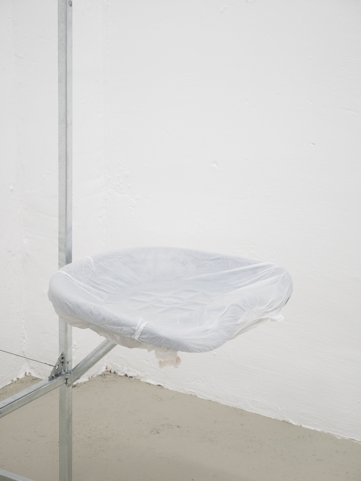 Clemens Tschurtschenthaler; socially detached figure; detail; 2023; galvanized steel, loden coat, plastic wraps, water; 129 x 170 x 69 cm