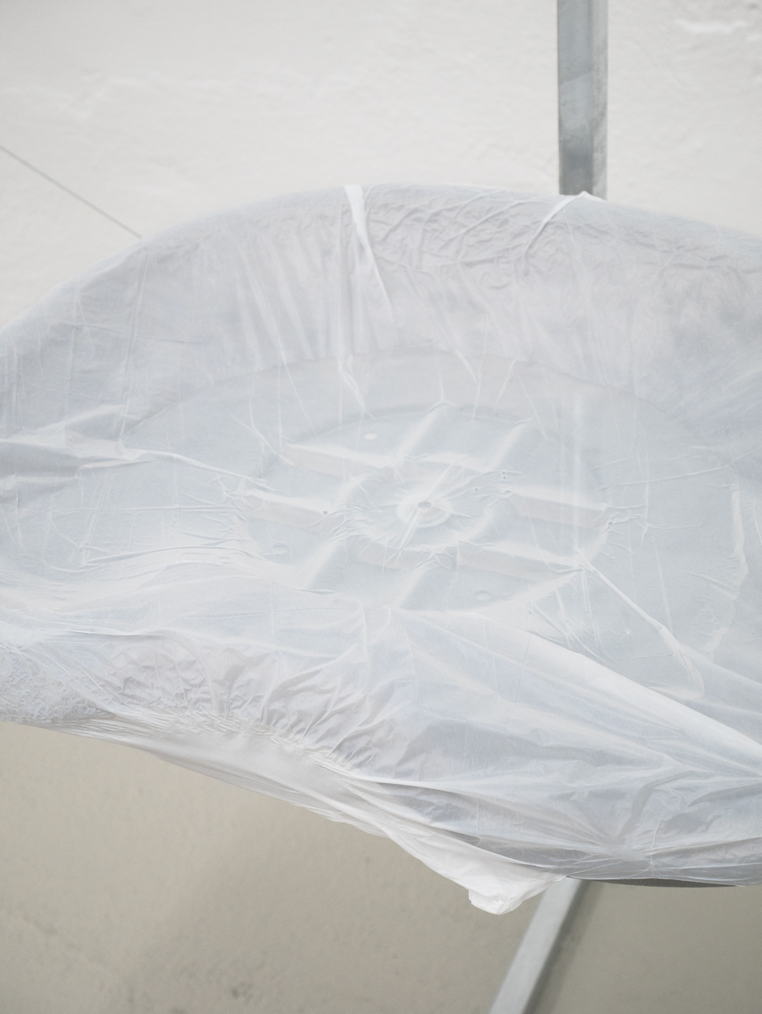 Clemens Tschurtschenthaler; socially detached figure; detail; 2023; galvanized steel, loden coat, plastic wraps, water; 129 x 170 x 69 cm