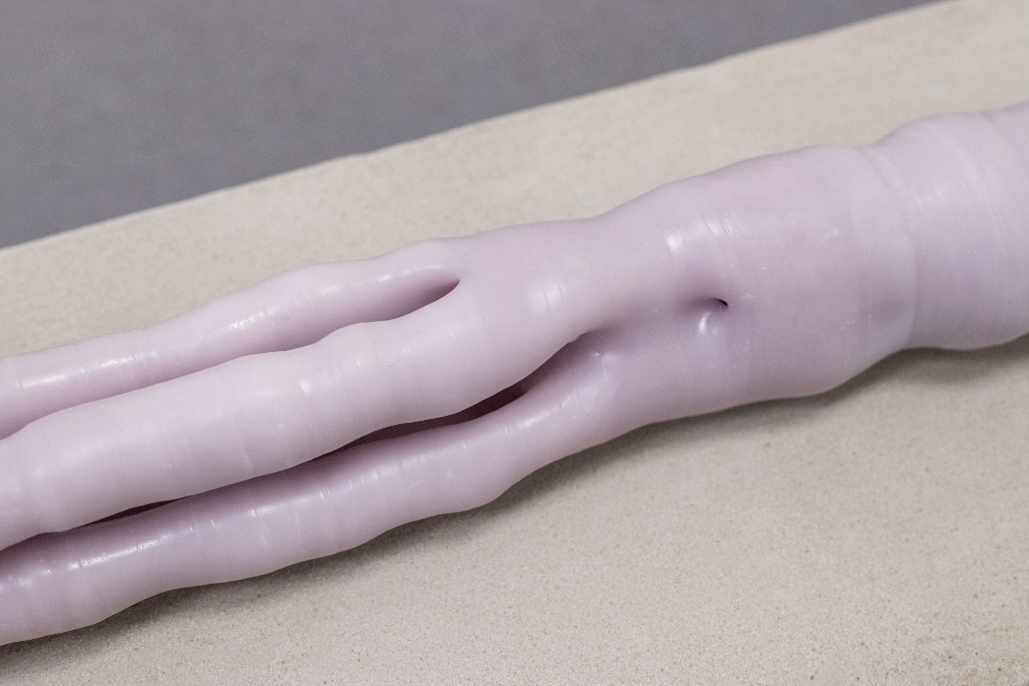 Pitted Dates: DOWNWELLING STARLIGHT, Elina Vainio: Amass, 2023, dyed beeswax, aluminium tube, linen sandbags, dimensions variable