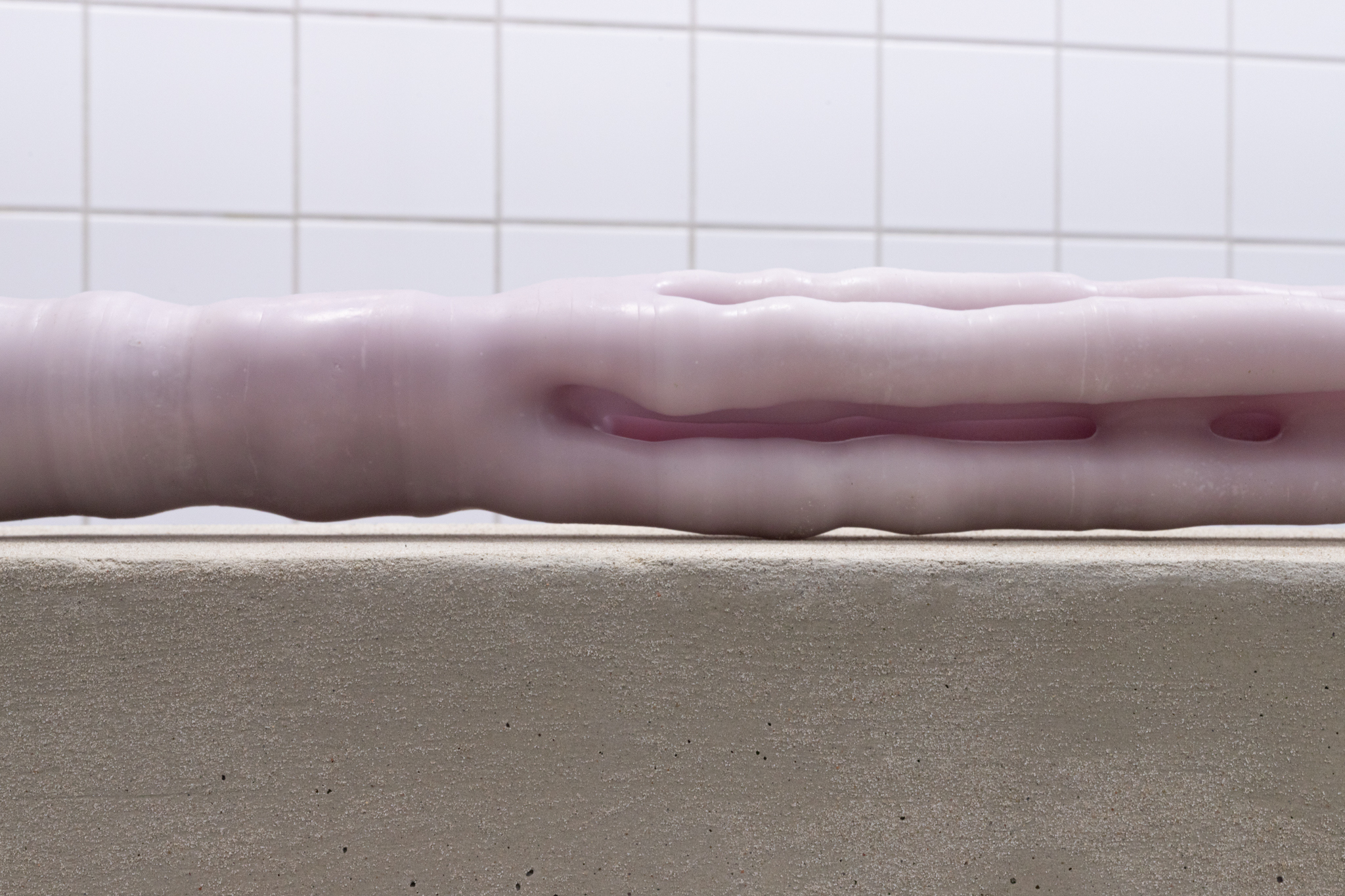 Pitted Dates: DOWNWELLING STARLIGHT, Elina Vainio: Amass, 2023, dyed beeswax, aluminium tube, linen sandbags, dimensions variable