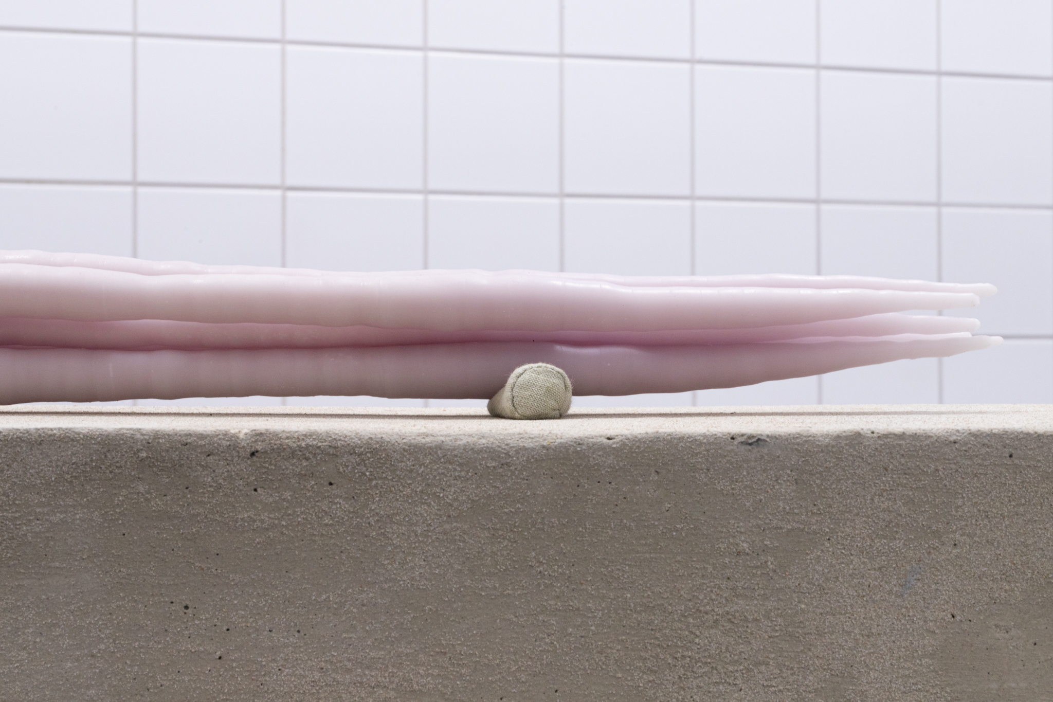 Pitted Dates: DOWNWELLING STARLIGHT, Elina Vainio: Amass, 2023, dyed beeswax, aluminium tube, linen sandbags, dimensions variable