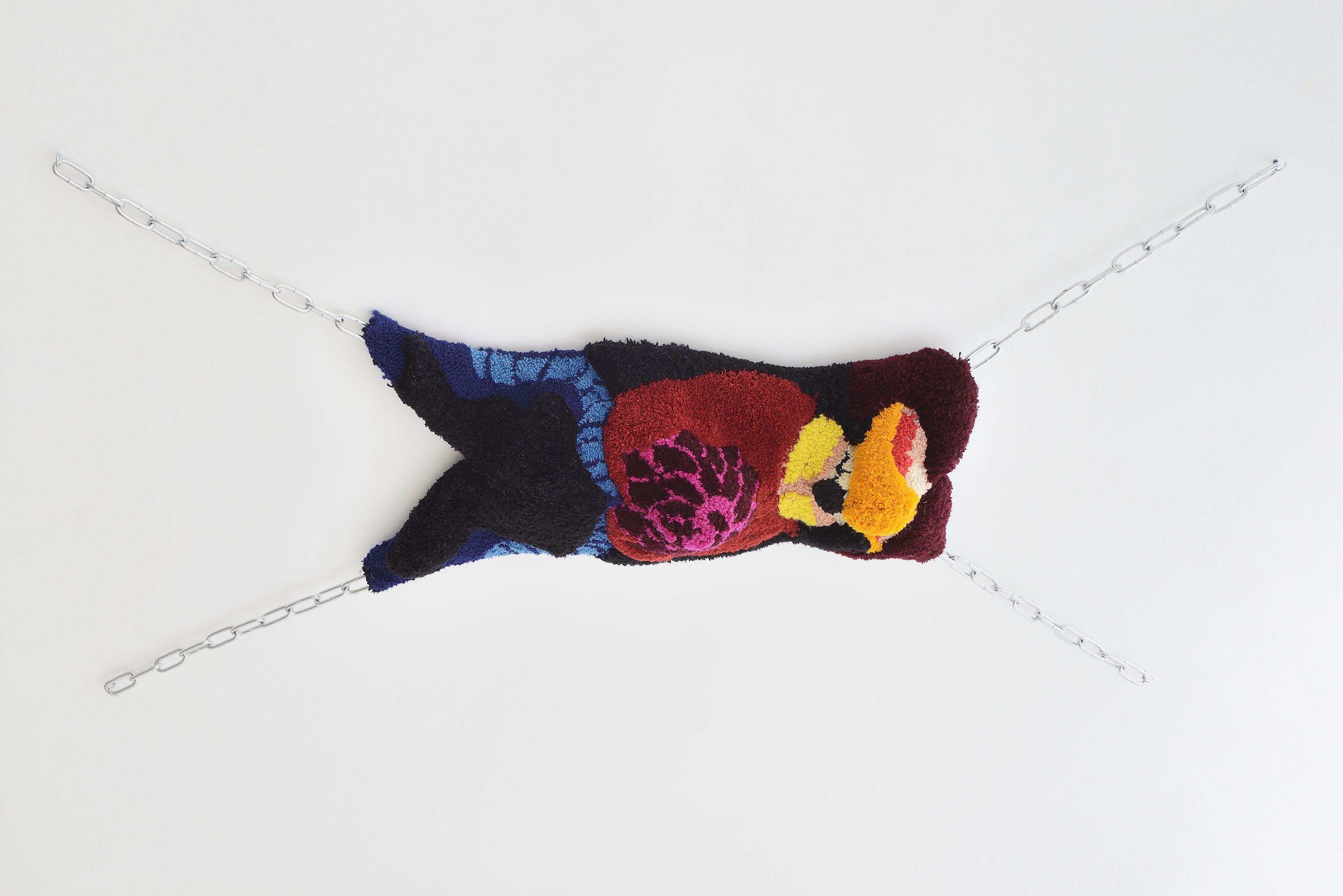 Anna Perach, The Rack, 2023, tufted Axminster yarn, metal chains, faux leather, 195 x 104 x 30 cm