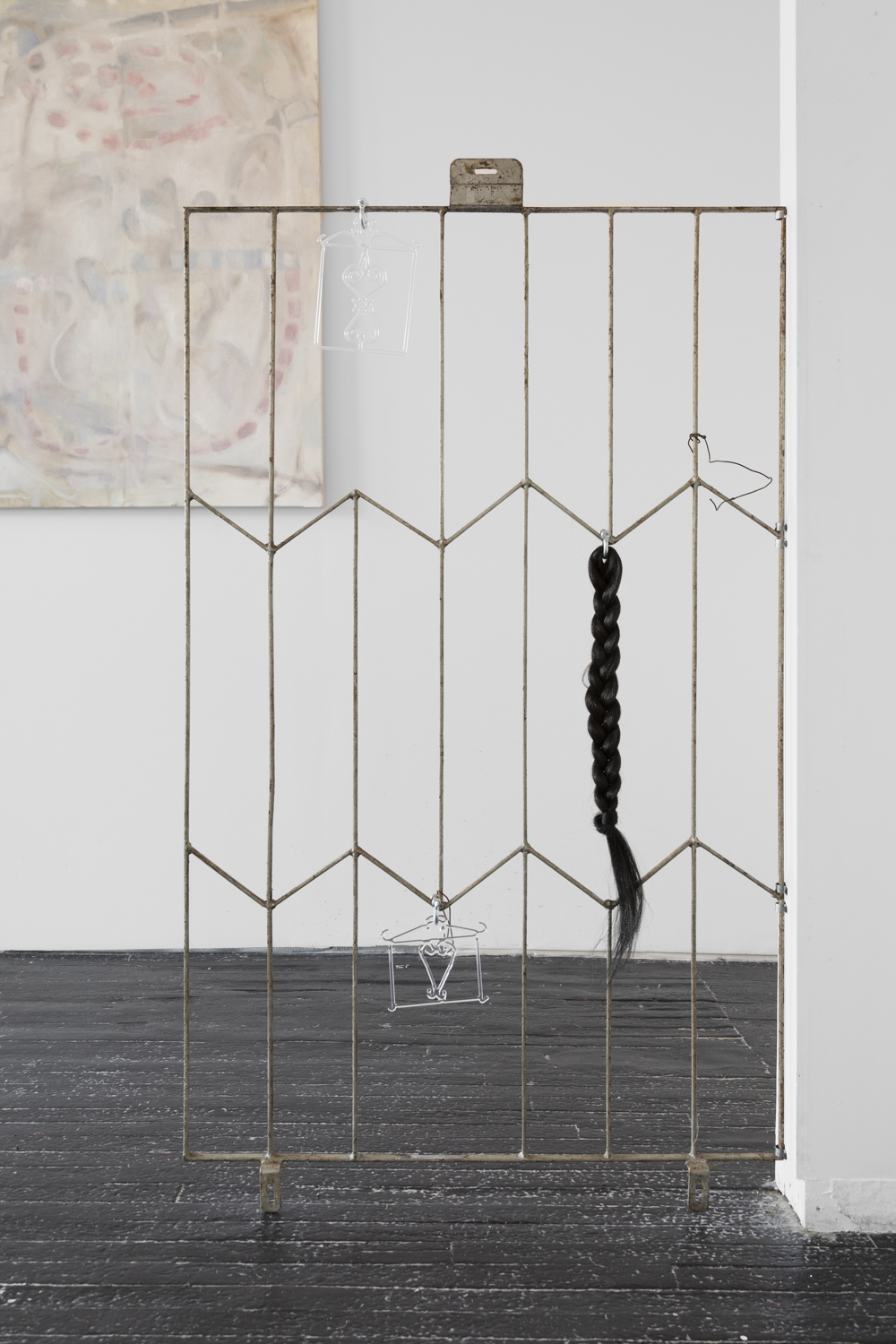 Installation shot, Adrienne Greenblatt Sheol i (2023) and Sheol ii (2023) and braided hair piece on antique steel fence