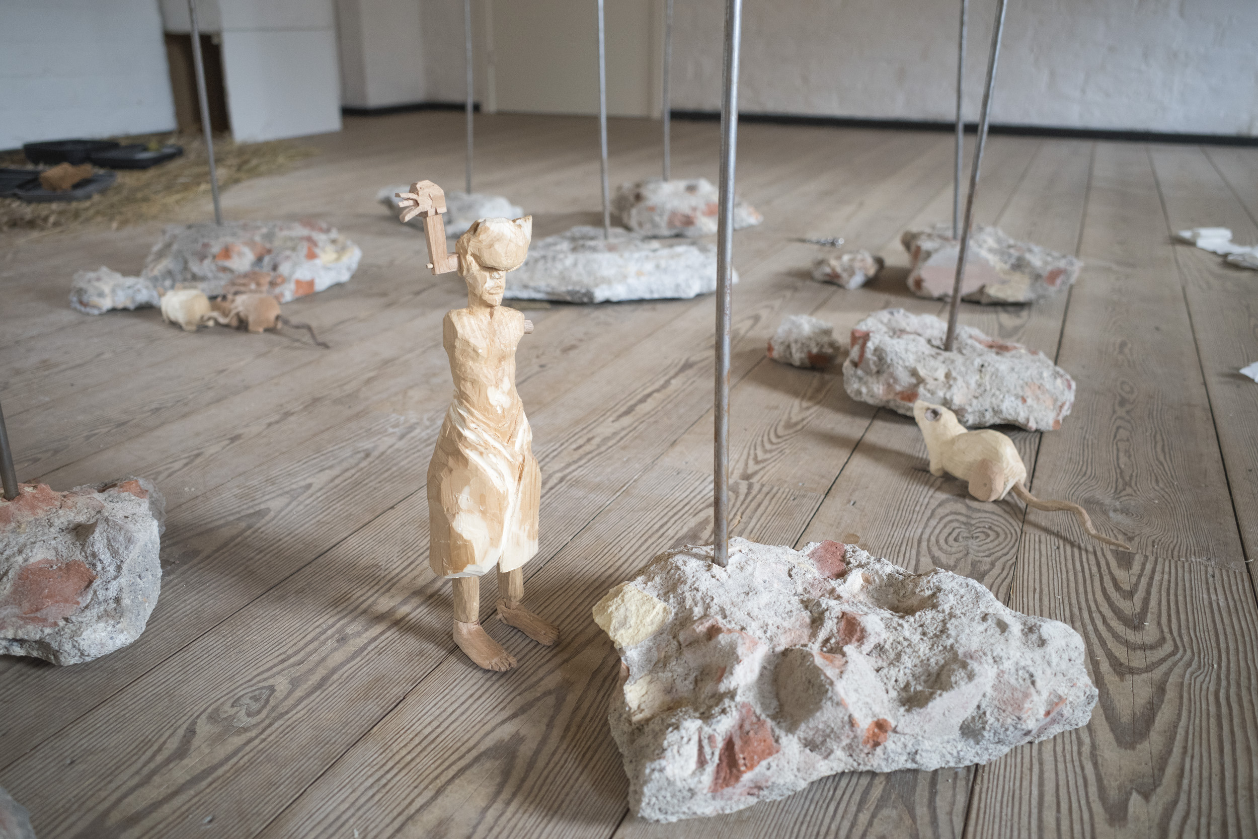 Anders Aarvik, Ayshan Qvortrup, Aske Hvitved, 0, performance (co-choreographed and performed by Ayshan Qvortrup), teasels, steel pipes, brick remains, sewn patient clothes, gauze bandage, wooden figurines (by Aske Hvitved), Variable dimensions