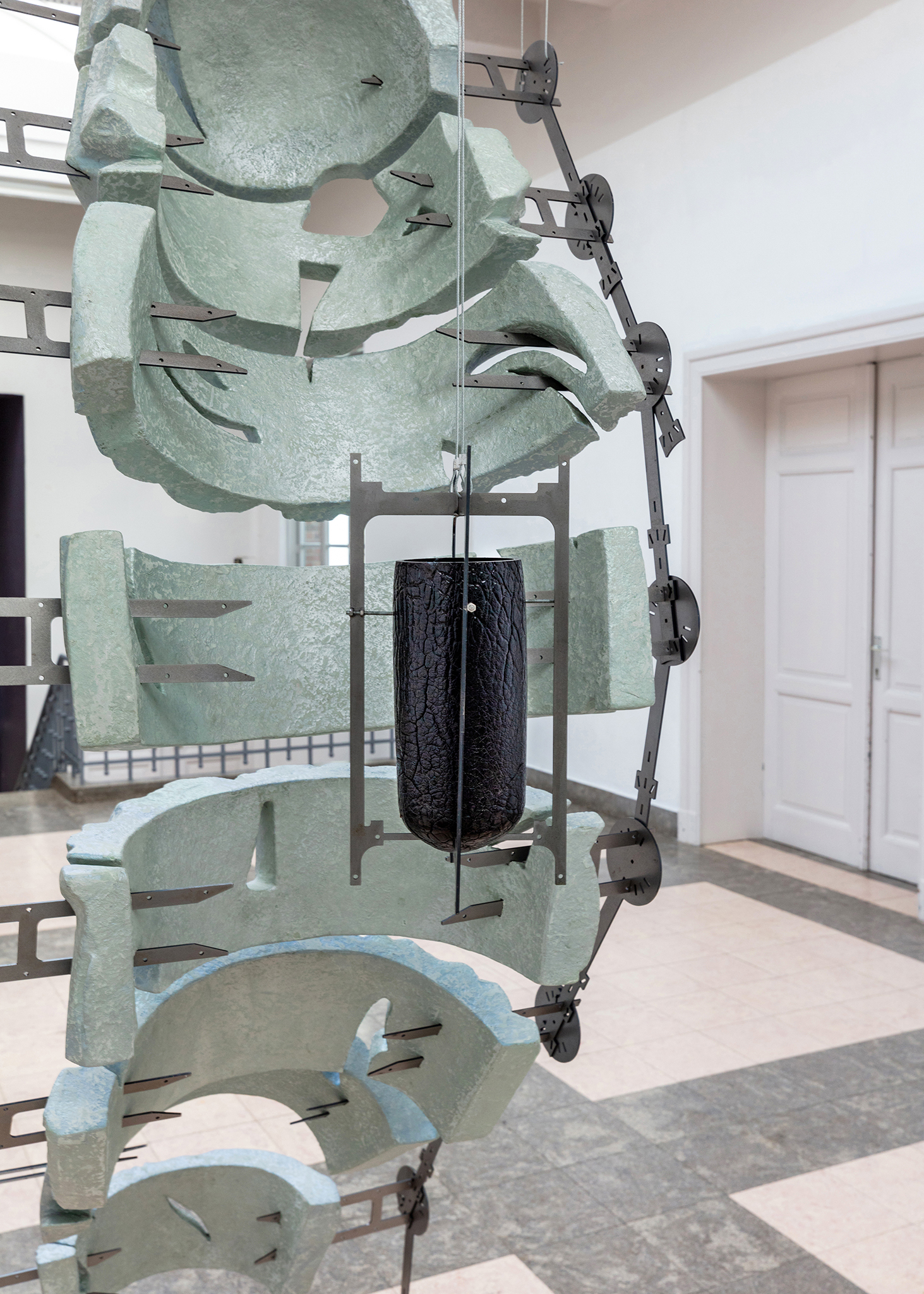 Confessional with a view, 2022, acrylic plaster, fiberglass, shimmering colors, steel, wheels black blown glass
