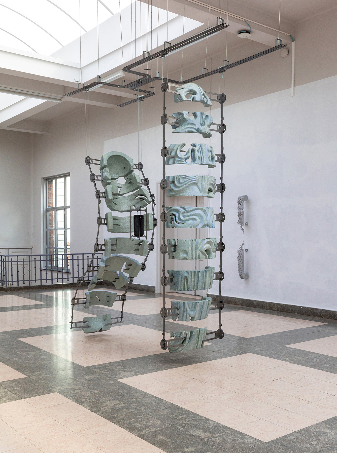 Confessional with a view, 2022, acrylic plaster, fiberglass, shimmering colors, steel, wheels black blown glass