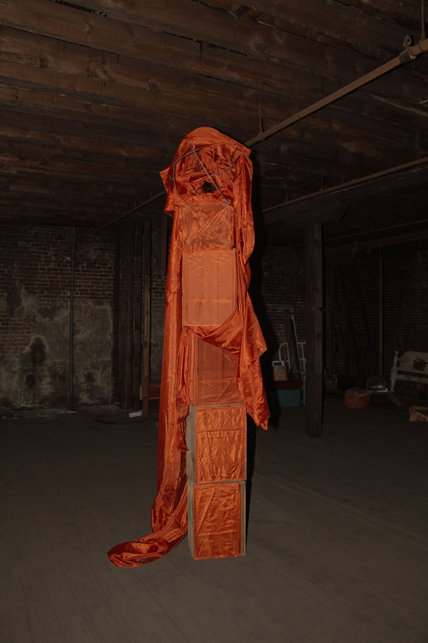 Tomm Roeschlein, untitled, 2023, Synthetic fabric, rusted steel circular frame, wood crates, pins. 