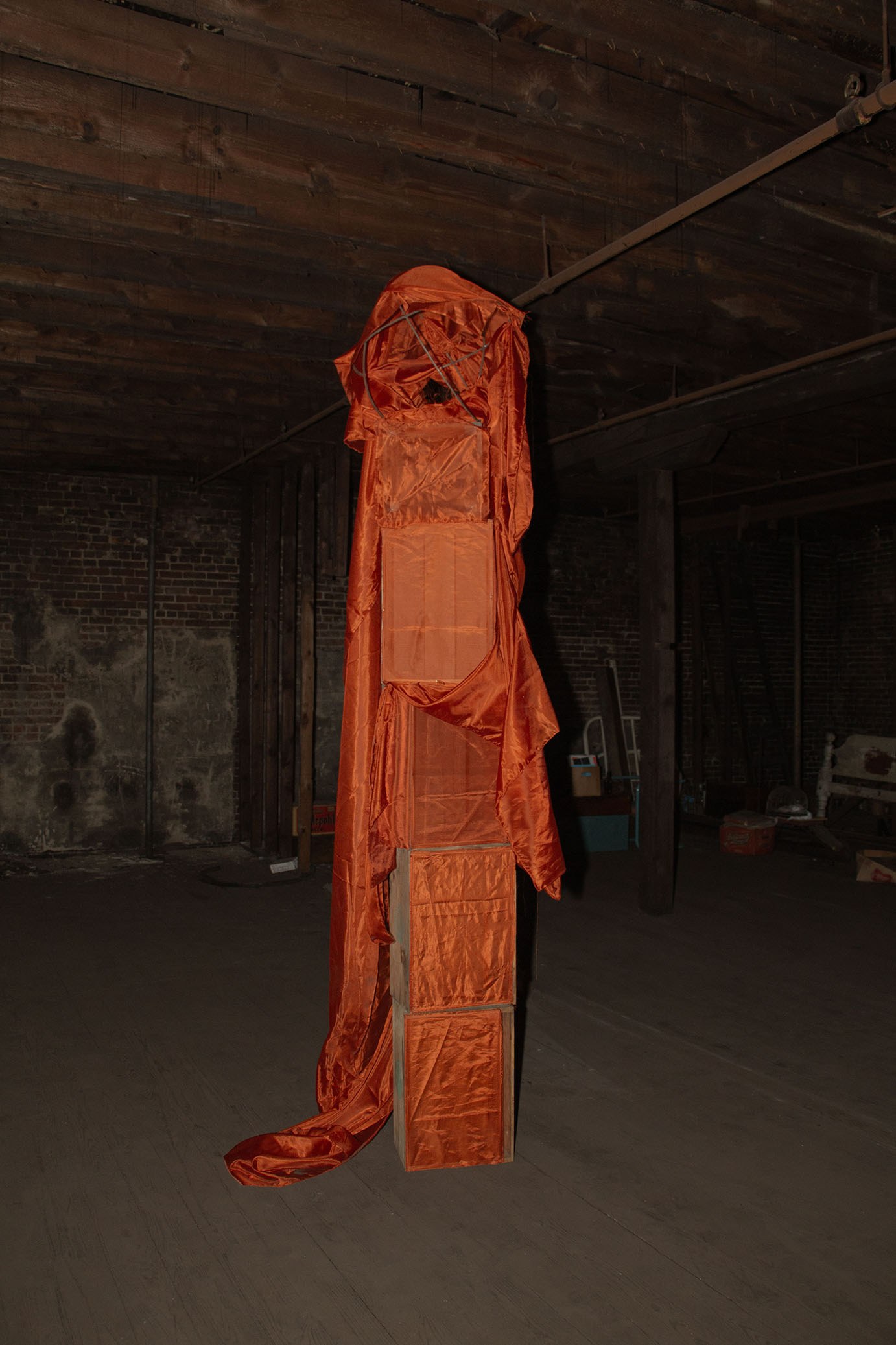 Tomm Roeschlein, untitled, 2023, Synthetic fabric, rusted steel circular frame, wood crates, pins.