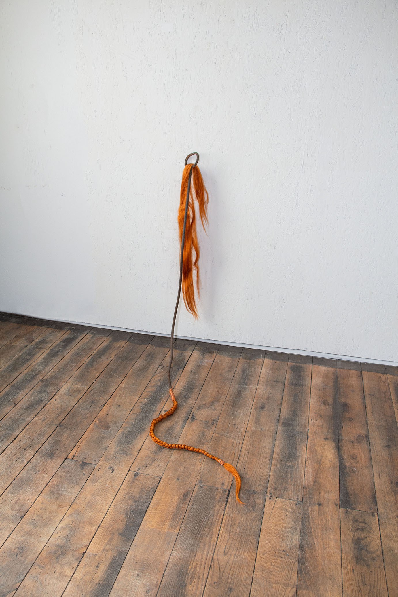 Cléo Sjölander, She can speak to snakes, 2023, synthetic hair, leather, rusty metal, 39x42x16in