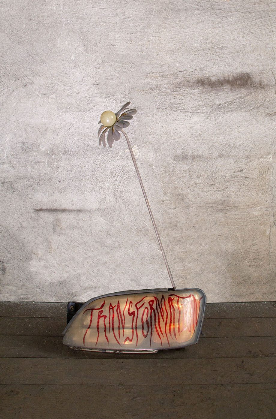 Cléo Sjölander, transformation, 2023, found metal flower, car light, 27 x 18 x 9 in