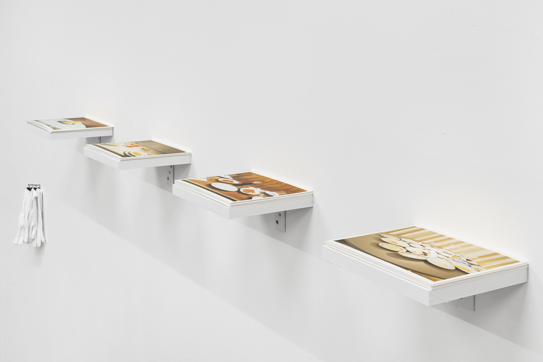 Exhibition View Group Show «Gulp; view on Jacopo Valentini, From the series Paesaggi da Tavola, 2023, Inkjet print, wood and cotton gloves, 20 x 220 cm» at La Rada, Locarno, 2023 / Photo: Riccardo Giancola / Courtesy: the artist and La Rada