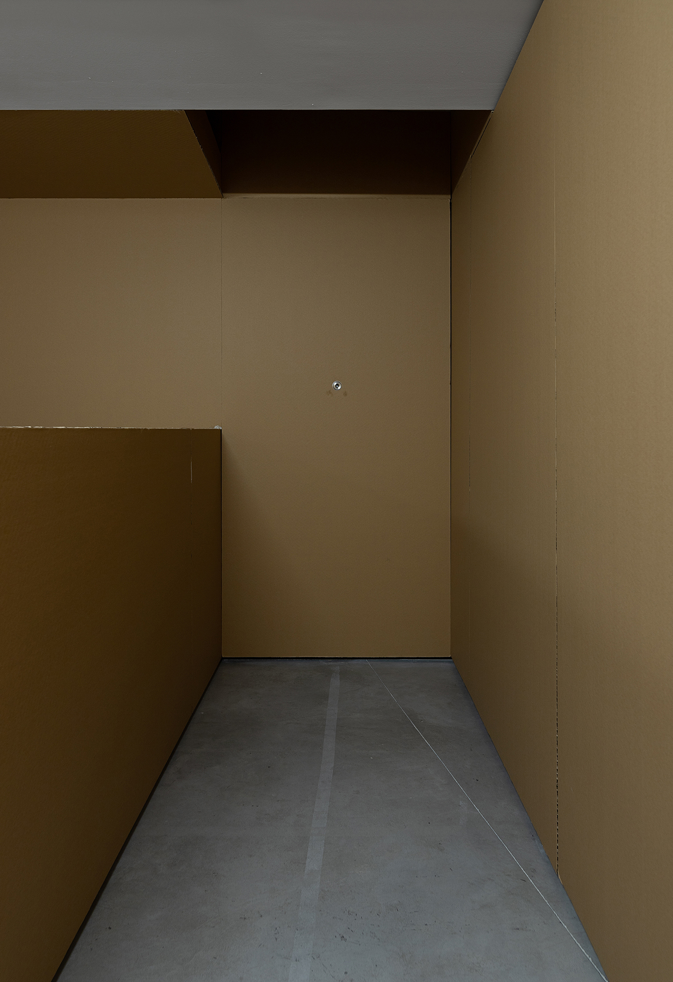 Ian Waelder. You Who Are The Stranger (Moth Joke), 2023. Door peephole on wall, muted video played on screen. 9 mins.