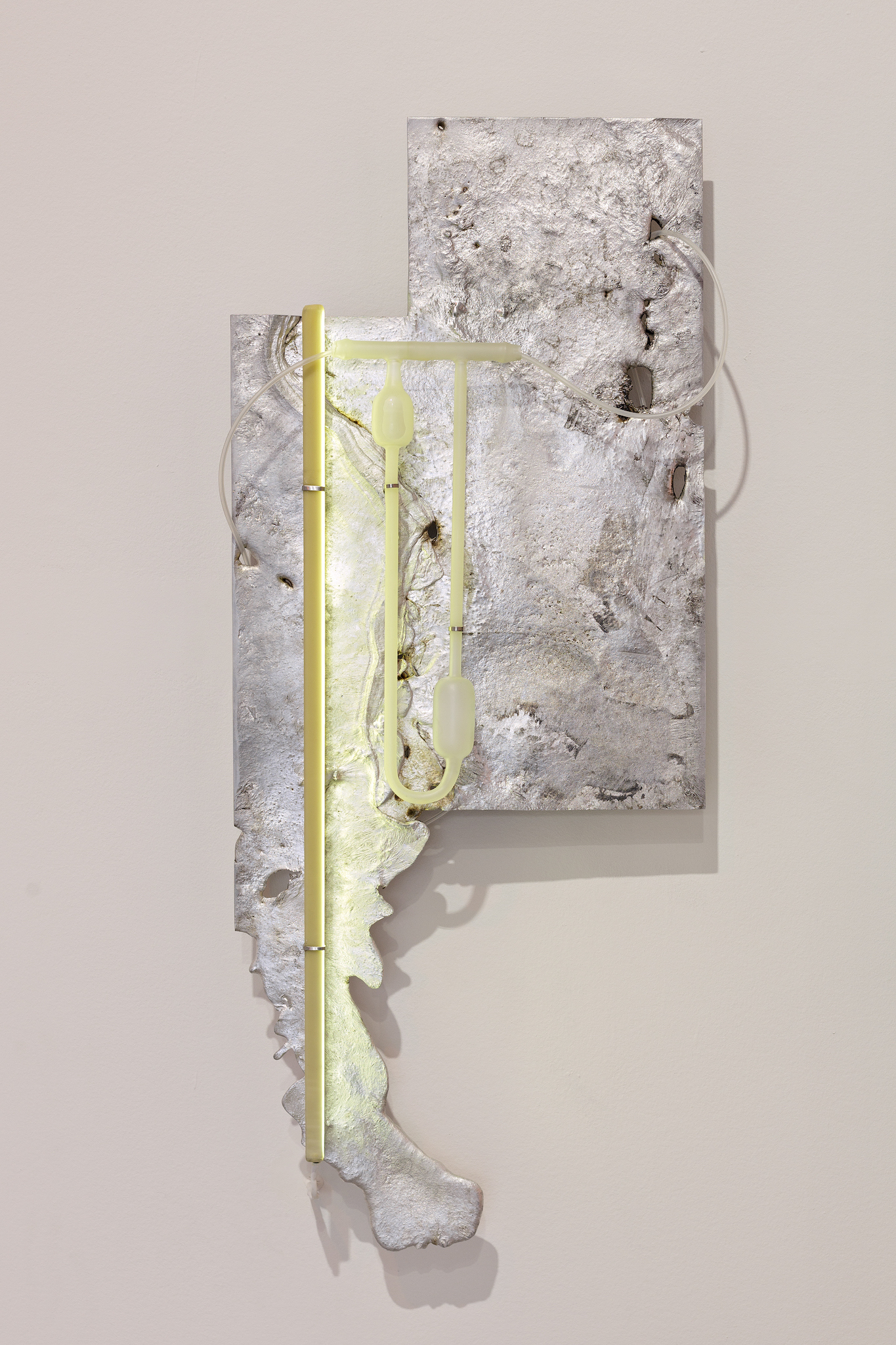 Pakui Hardware, Heat Treated, 2024. Casted aluminium, laboratory glass, bees wax, silicone rubber, stainless steel, LED light, 89x36x11 cm