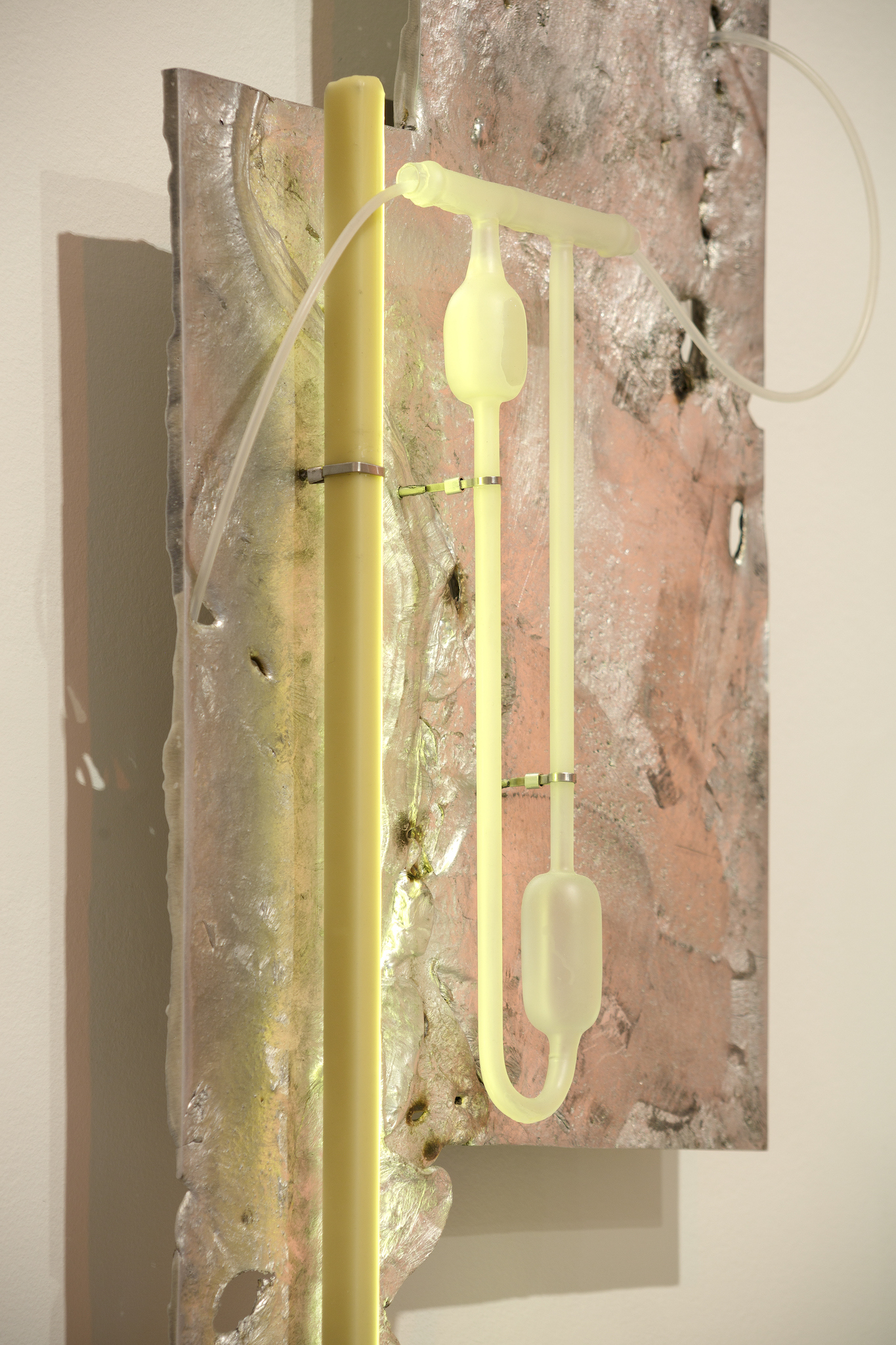 Pakui Hardware, Heat Treated, 2024. Casted aluminium, laboratory glass, bees wax, silicone rubber, stainless steel, LED light, 89x36x11 cm