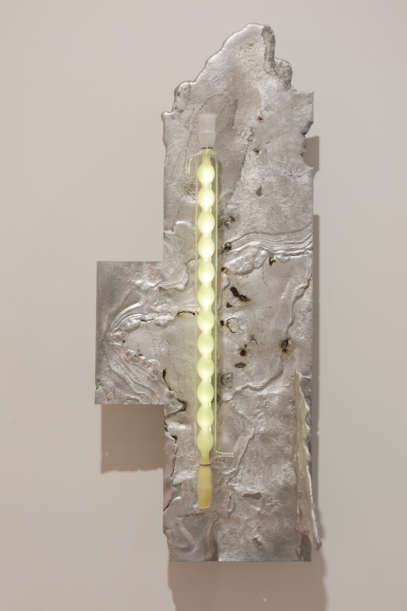 Pakui Hardware, Heat Treated, 2024. Casted aluminium, laboratory glass, bees wax, stainless steel, LED light, 107x42,5x26 cm