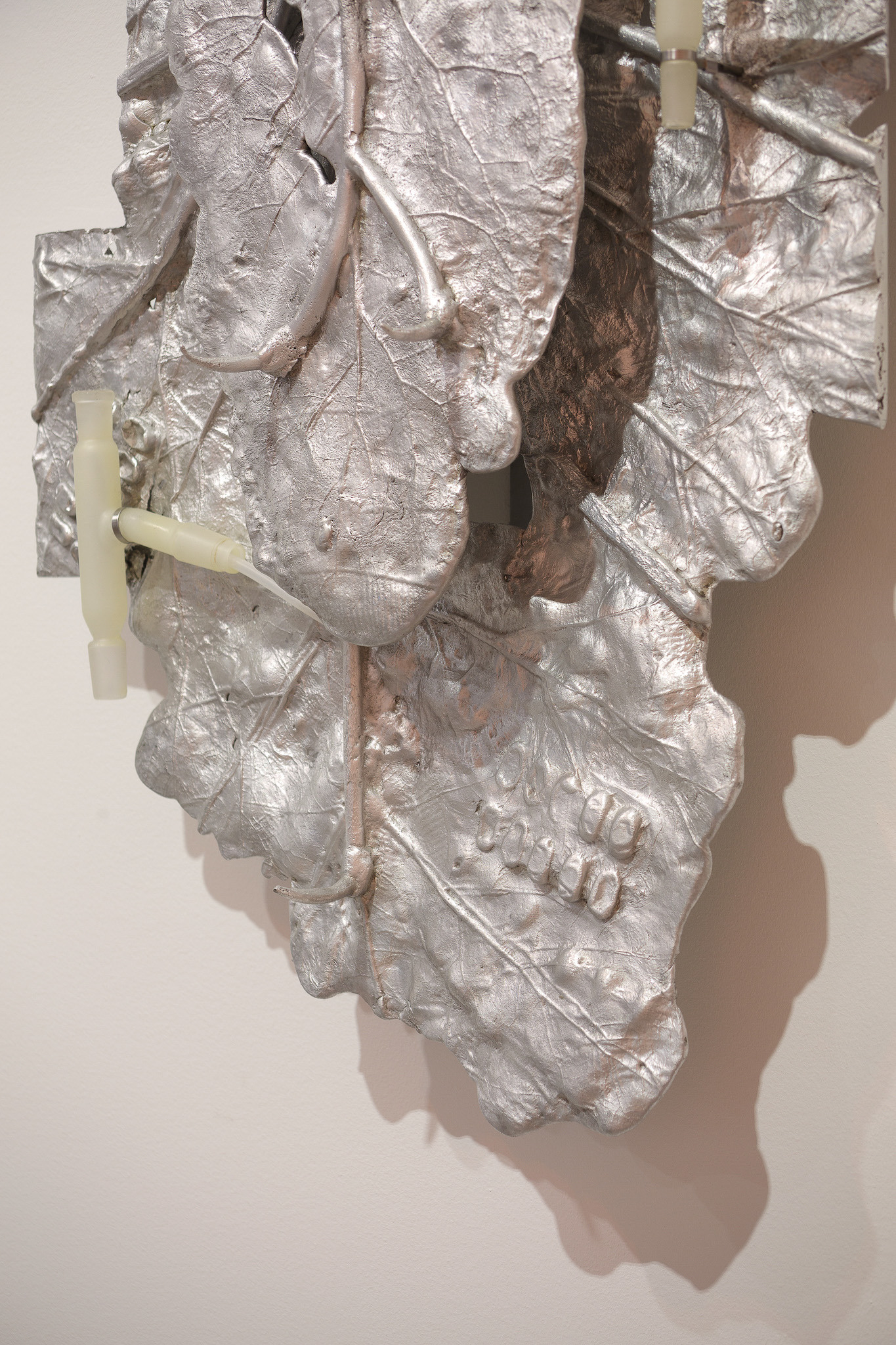 Pakui Hardware, Heat Treated, 2024. Casted aluminium, laboratory glass, bees wax, stainless steel, silicone rubber, 85x50x11 cm