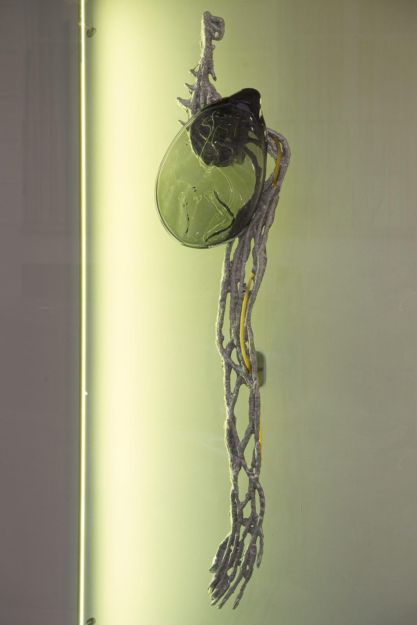 Pakui Hardware, Inflammation, 2024. Casted aluminium, glass,  rubber, bees wax, LED light, stainless steel, 175x43x18 cm