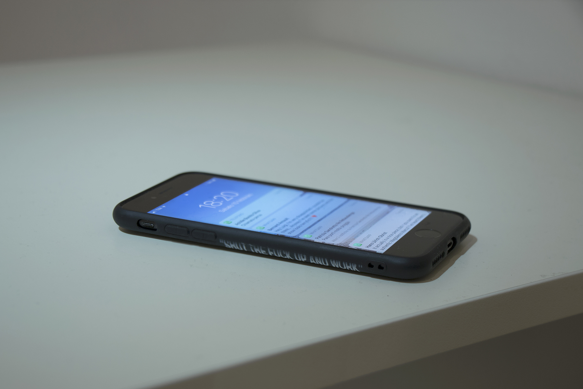 Andrea Magnani, SHUT THE FUCK UP AND WORK, 2024. Laminated wood, plastic, digital print on paper, uv print on mobile phone cover, mobile phone. 120 x 53 x 77 cm.