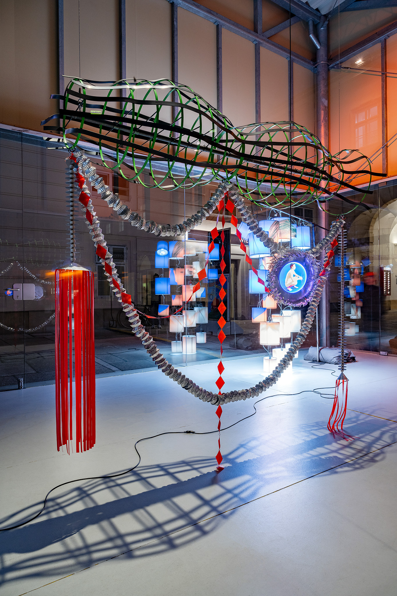 Paul R.1 (Amulett), 2024 Steel, paint, wood, plastic, industrial aluminum foil, rubber, magnets, foil laminated on Plexiglas, lamps, cable, 196 x 220 x 50 cm