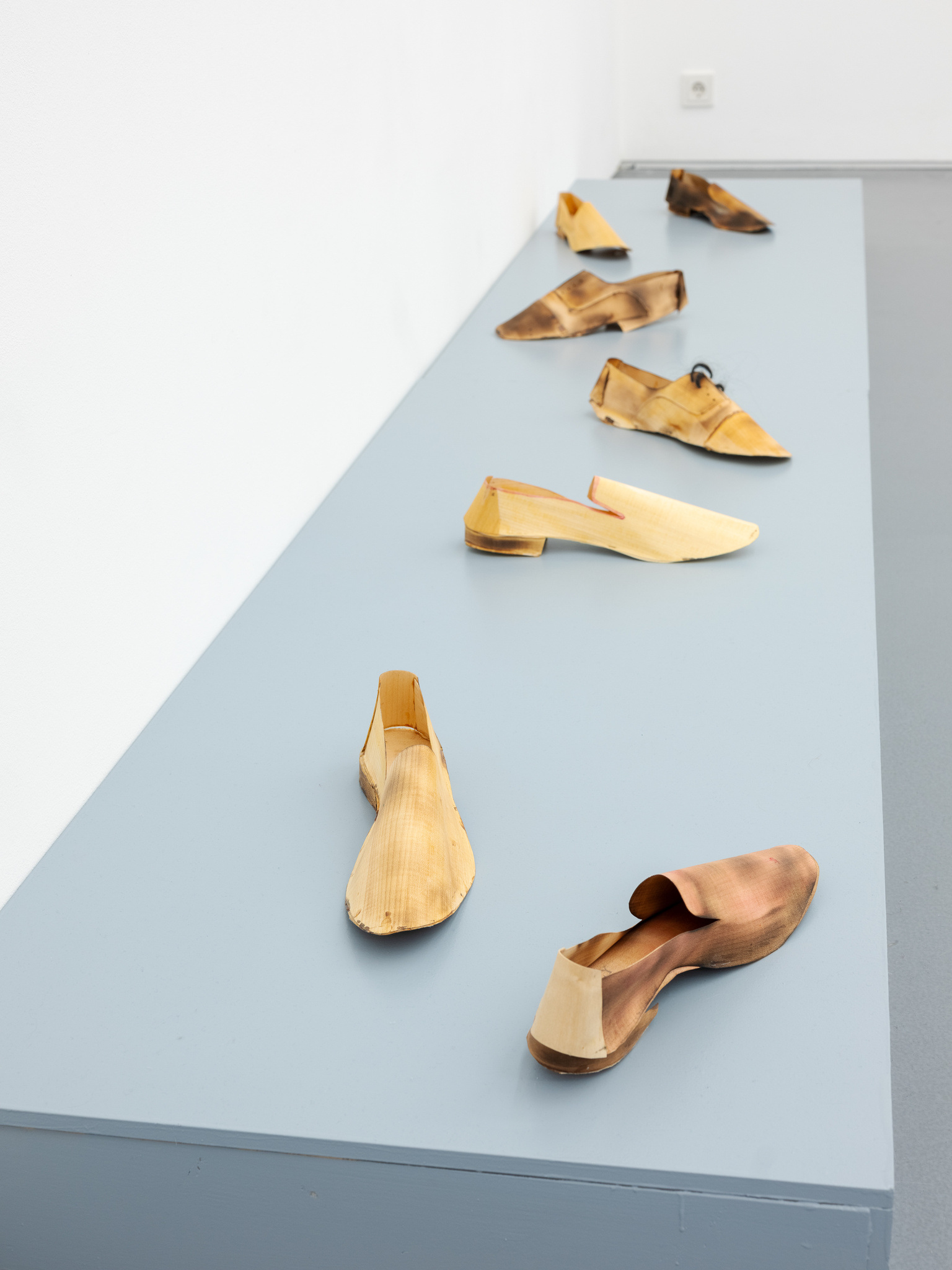Anne Schmidt, 2020 · Veneer wood, heat, oil glaze · Each shoe 42 × 15 × 15 cm · Unique
