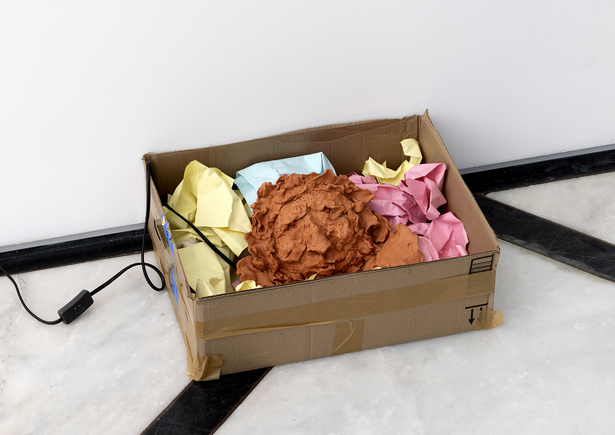 Untitled, 2024, bisqueware, lamp, colorful paper and cardboard, variable dimensions
