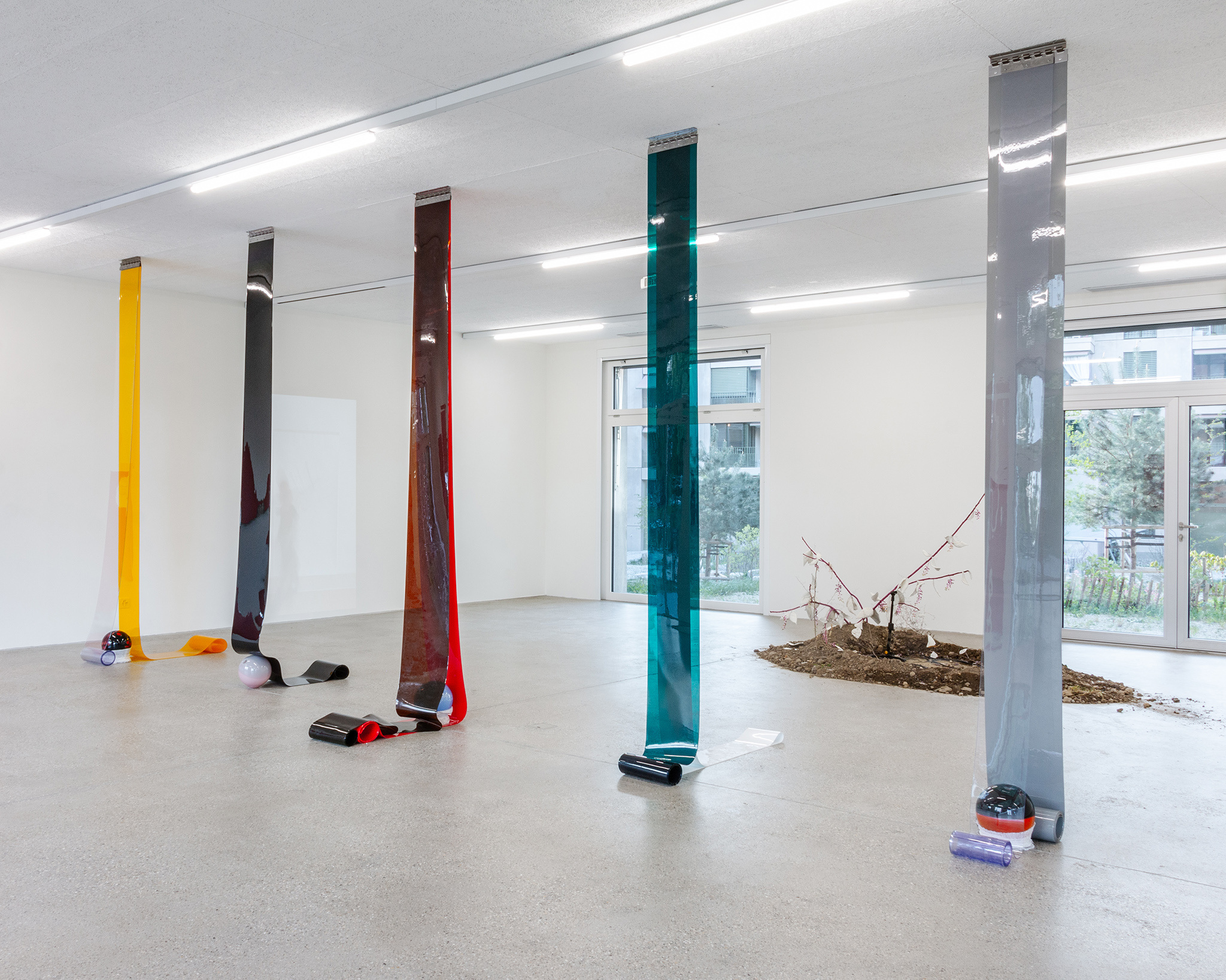 Exhibition view Our Labor, Our Passion, Our Love; Charly Mirambeau, Private Pursuits and Public Problems, 2024, stainless steel rail, PVC, glass, fabric, CALM - Centre d'Art La Meute, 2024 / Photo: Théo Duﬂoo / Courtesy of the artist.