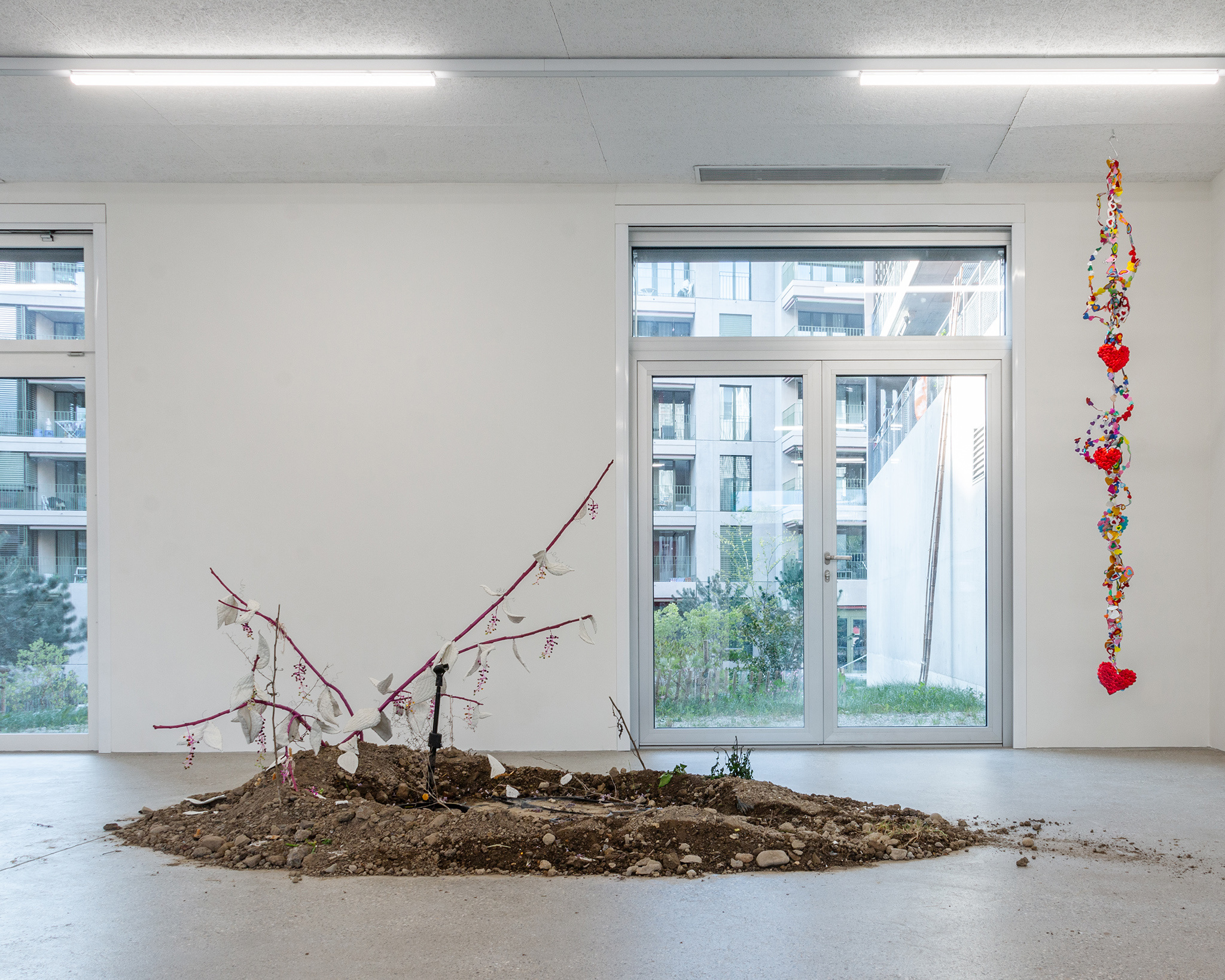 Exhibition view Our Labor, Our Passion, Our Love; Juri Bizzotto, Phytolacca Vol. 1, 2024, installation and performance, branches, beads, fabric, microphone, CALM Centre d'Art La Meute, 2024 / Photo: Théo Duﬂoo / Courtesy of the artistex.