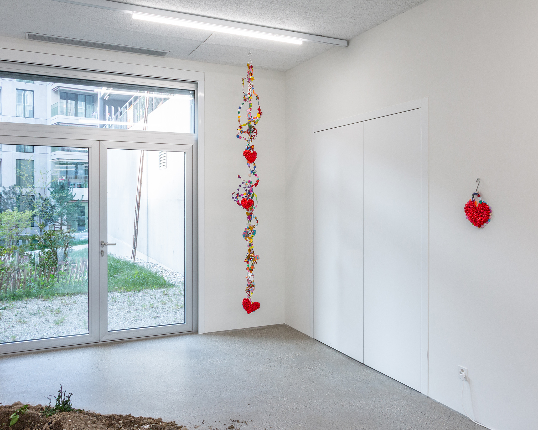 Exhibition view “Our Labor, Our Passion, Our Love”; Marisabel Arias, I am only for you; I am only for you love, 2024, sponge hearts, glitter, hook, CALM - Centre d'Art La Meute, 2024 / Photo: Théo Duﬂoo / Courtesy of the artist.