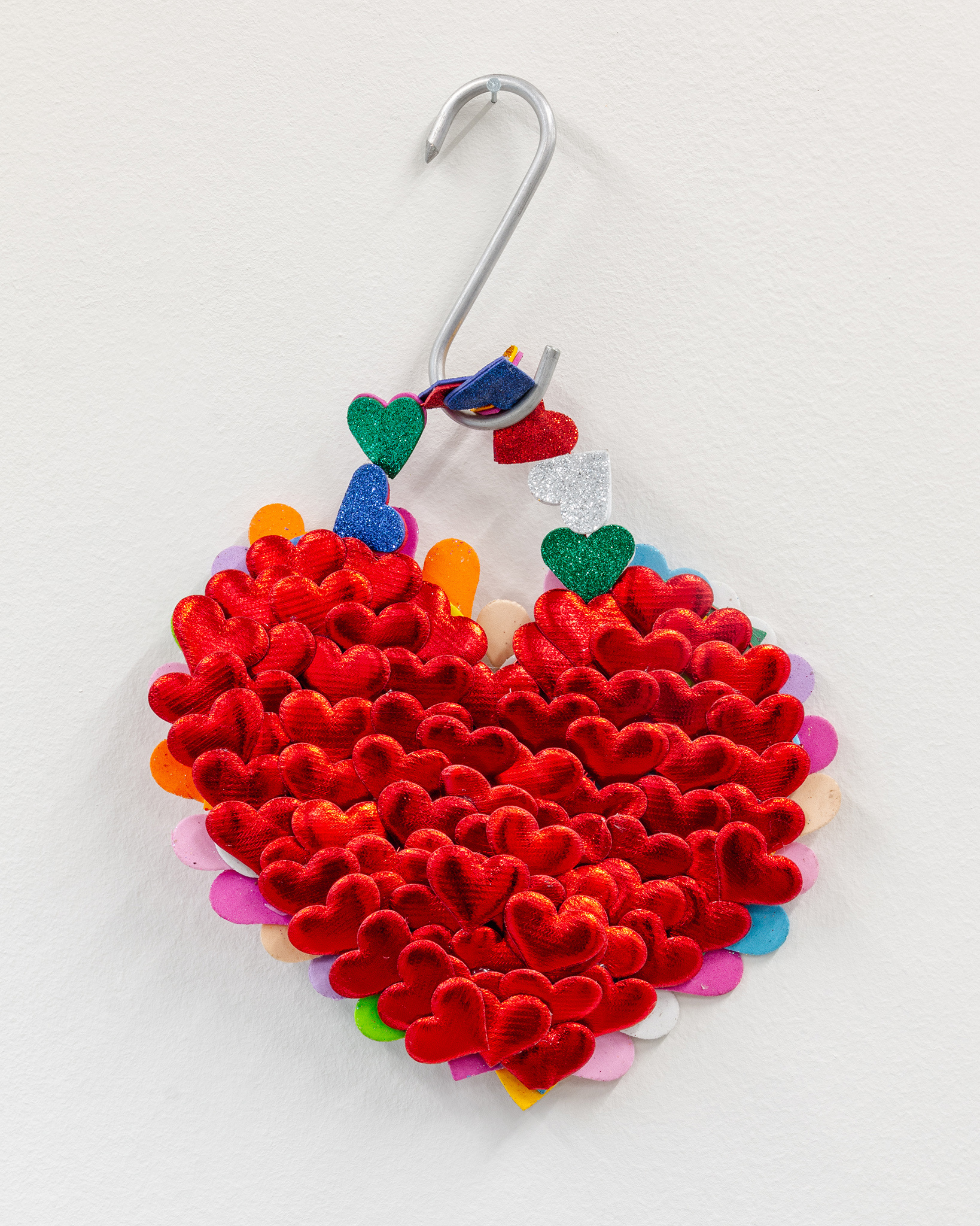 Exhibition view Our Labor, Our Passion, Our Love; Marisabel Arias, I am only for you love, detail, 2024, hearts, glitter, hook, 25x37x10cm, CALM – Centre d’Art La Meute, 2024 / Photo: Théo Duﬂoo / Courtesy of the artist.