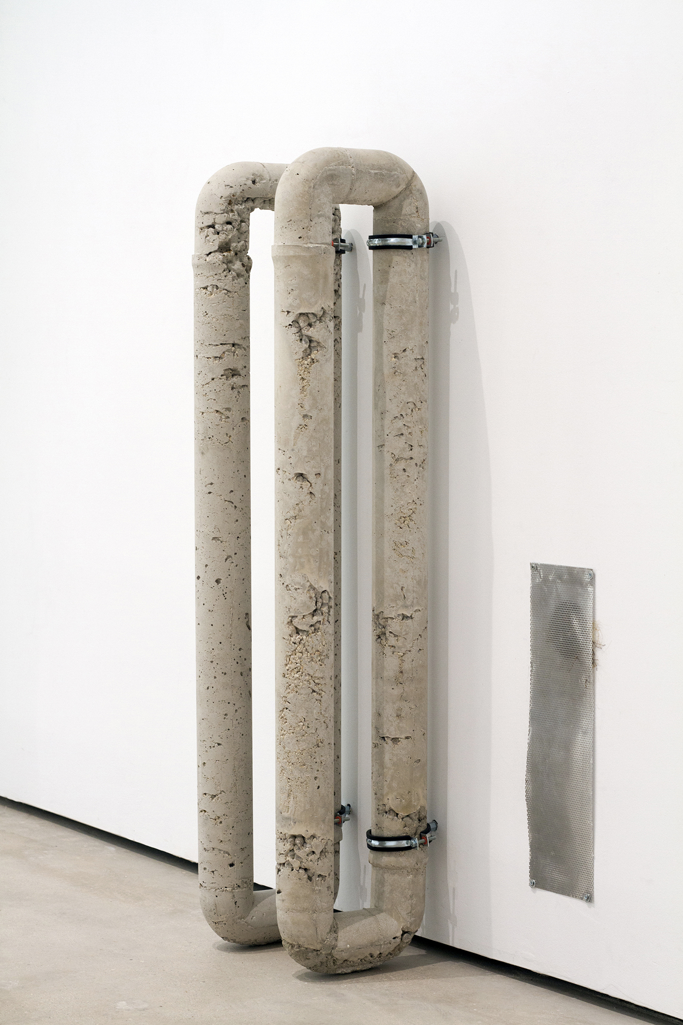 Untitled, 2024. Concrete, clamps and perforated metal. 120 x 35 x 25 cm