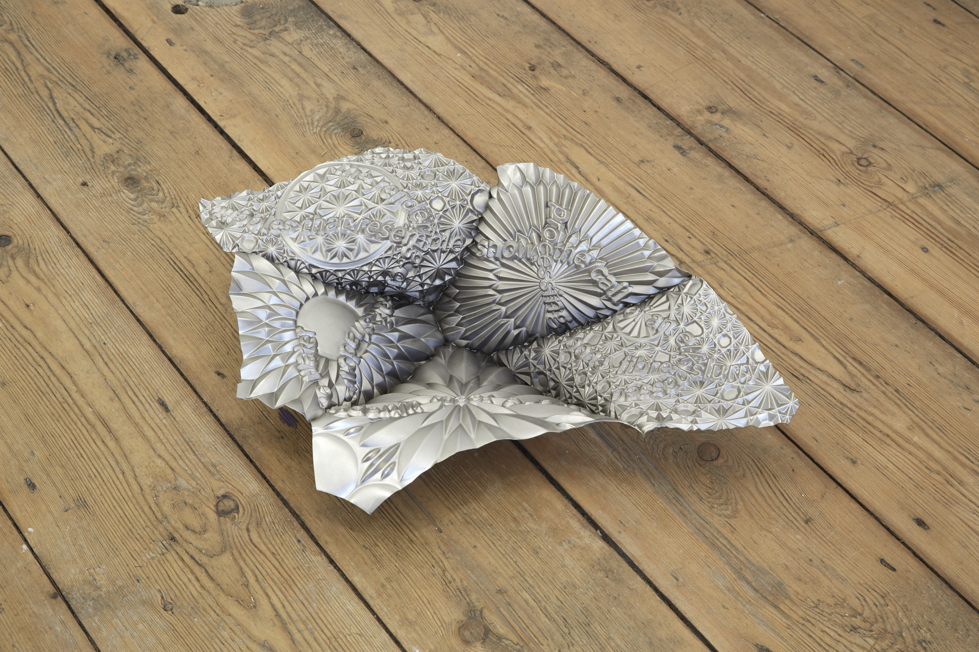 James Fuller, Slow scroller (the rendering of soft shadows), 2024. Nickel plated copper. 50(L) x 32(W) x 11(D) cm
