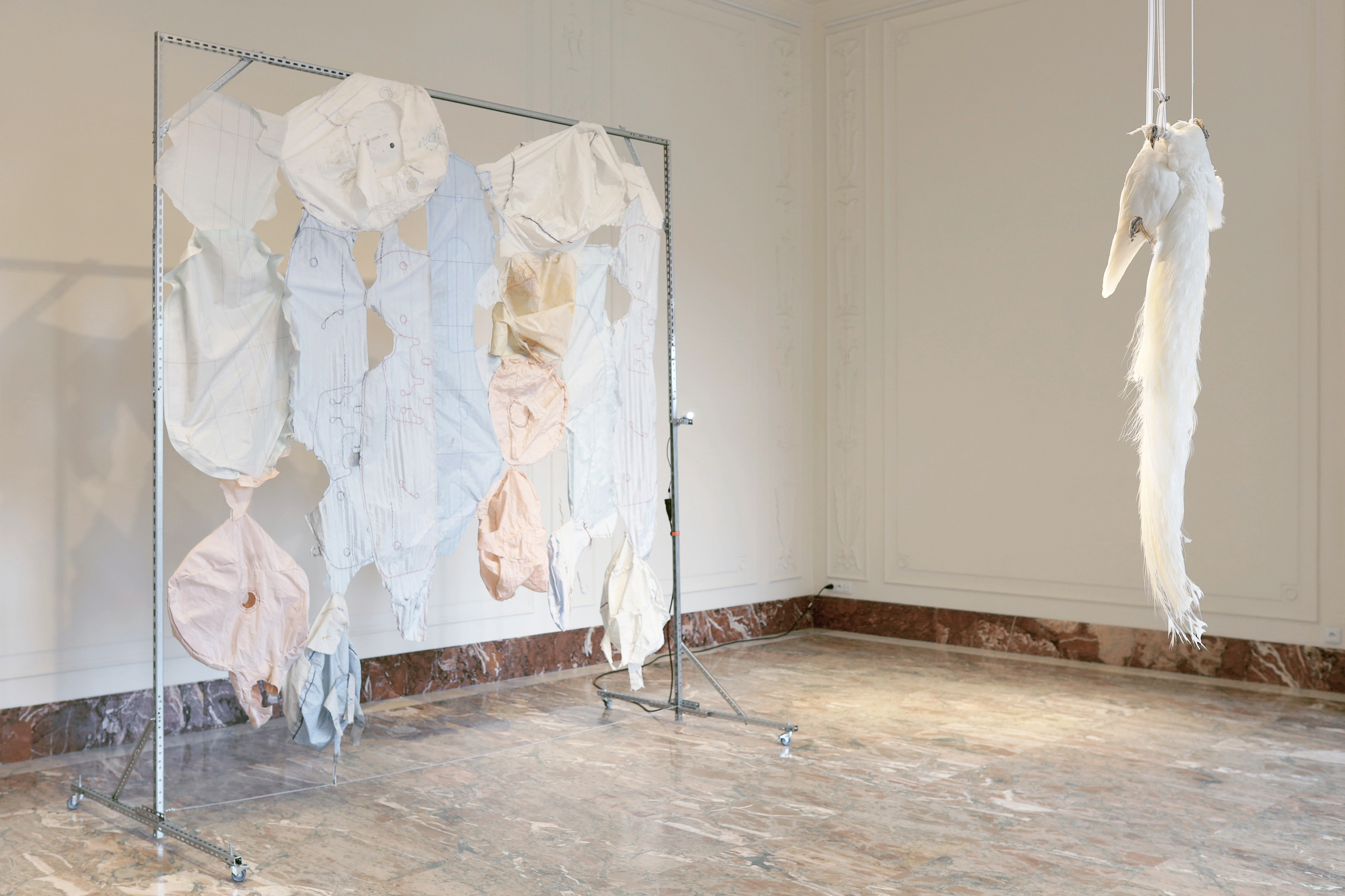 Marek Wodzisławski, barrier/utopia, installation: taxidermed albino peacock, reflective paint, airbags form damaged vehicles, 2024