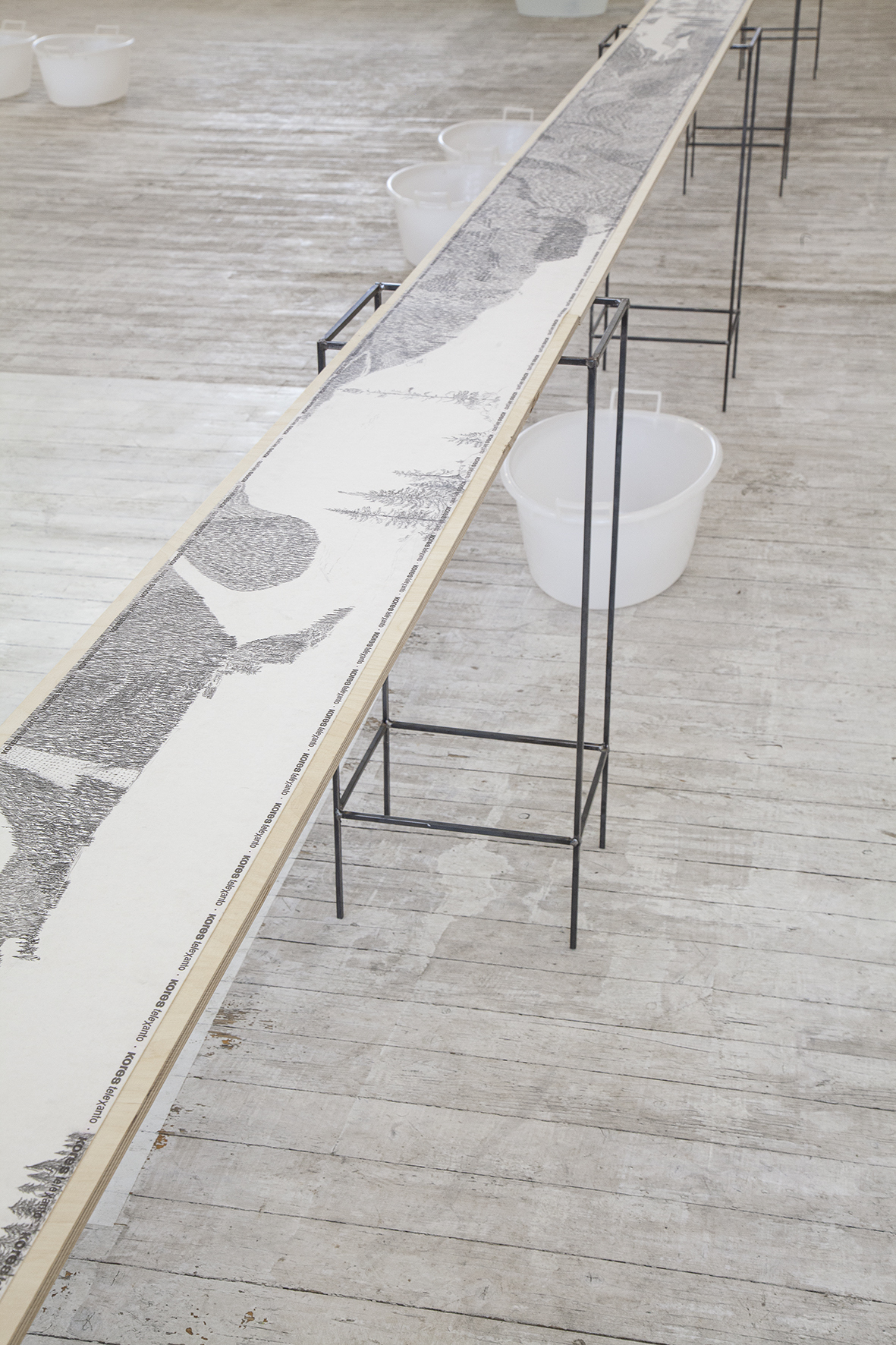Maria Bussmann; Wood-Roll (detail); pencil drawing on facsimile paper roll; 22 x 960 cm; 2012 (format of presentation: small metal tables and boards, 2024)