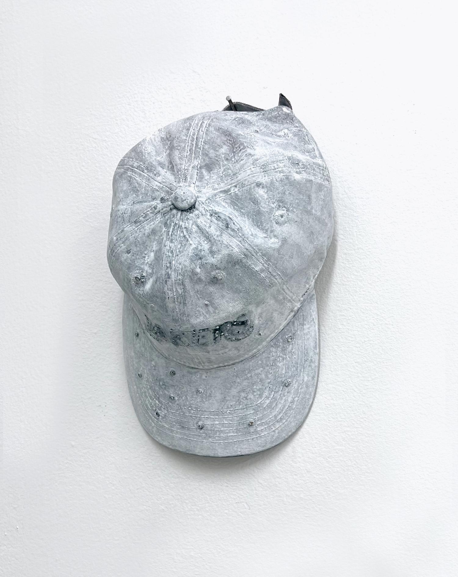 Sandra Ono, Untitled (2403), 2024 Laker hat, acrylic, sand, resin, dye, crystal necklace charm, sterling silver plumeria necklace charm, pearls 8 x 12 x 5 in.