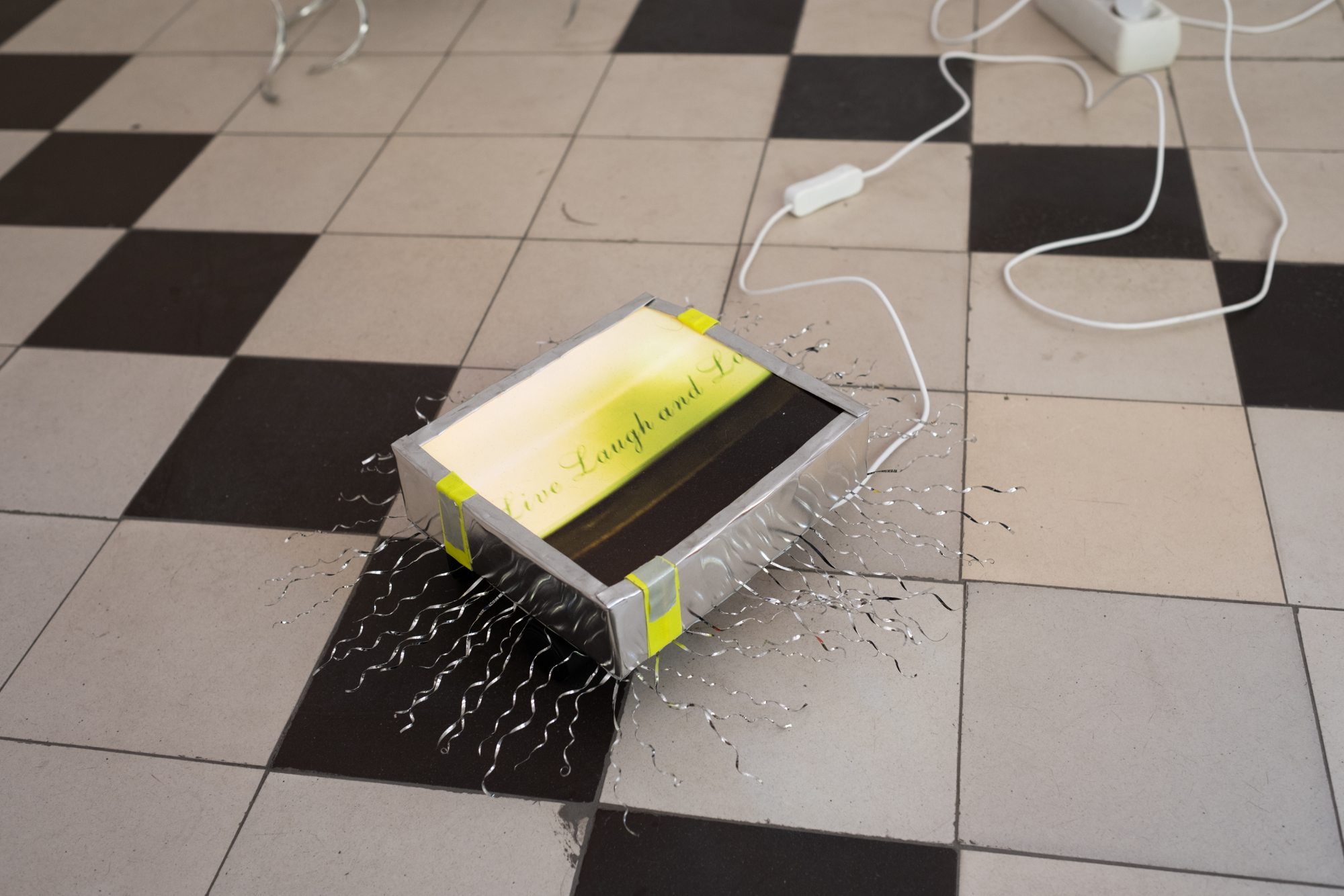 Janne Punkari, LLL lightbox bug, 2024, photograph, coffee can, cardboard, tape, wheels and LED lighting strip. Image: Inari Sandell.