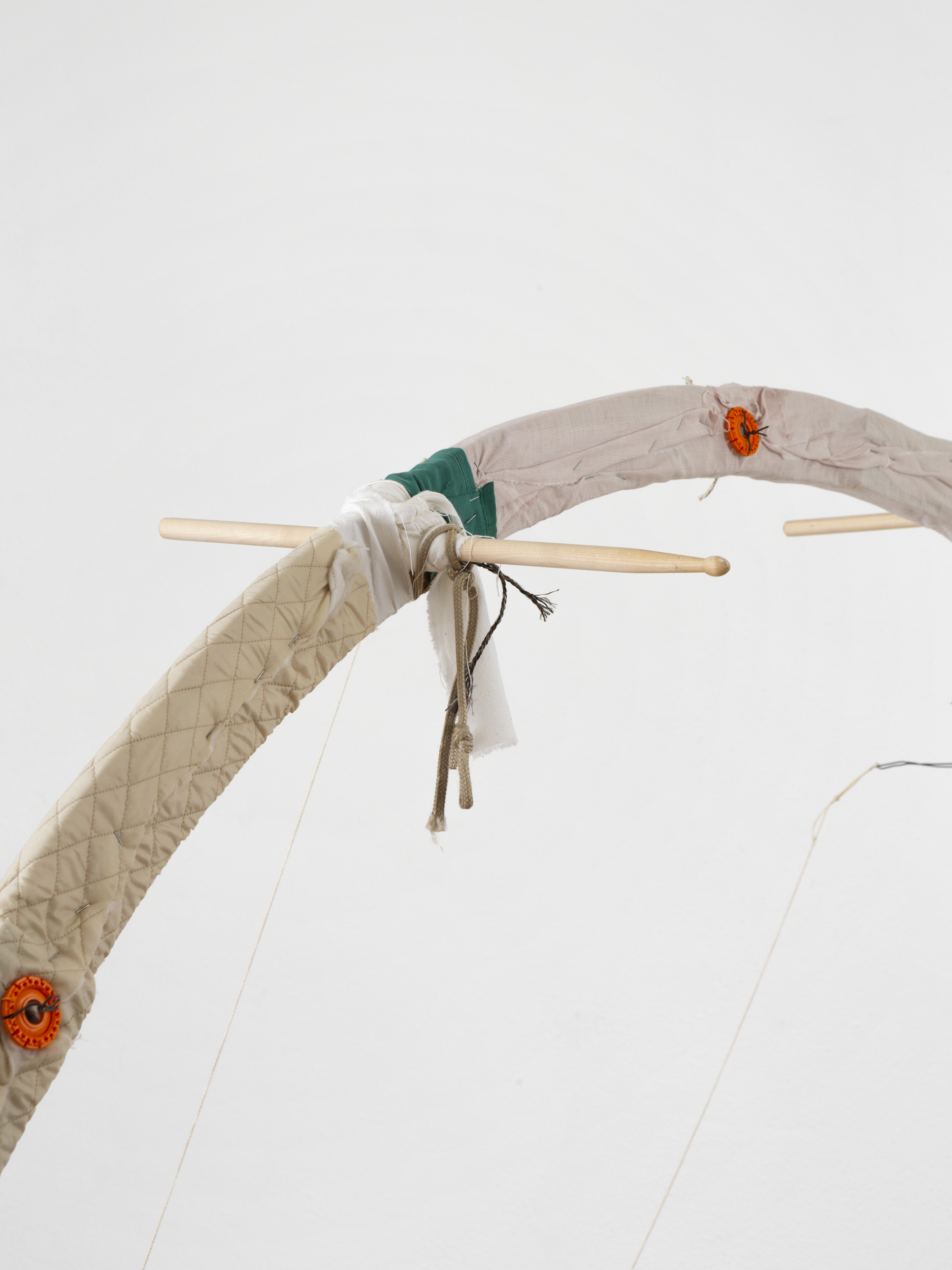 detail shot_Manuel Schneider , Loom Large In The Mind, 2024, Wood, drum sticks, textiles, thread, wire, staples, bells, 220 x 220 cm