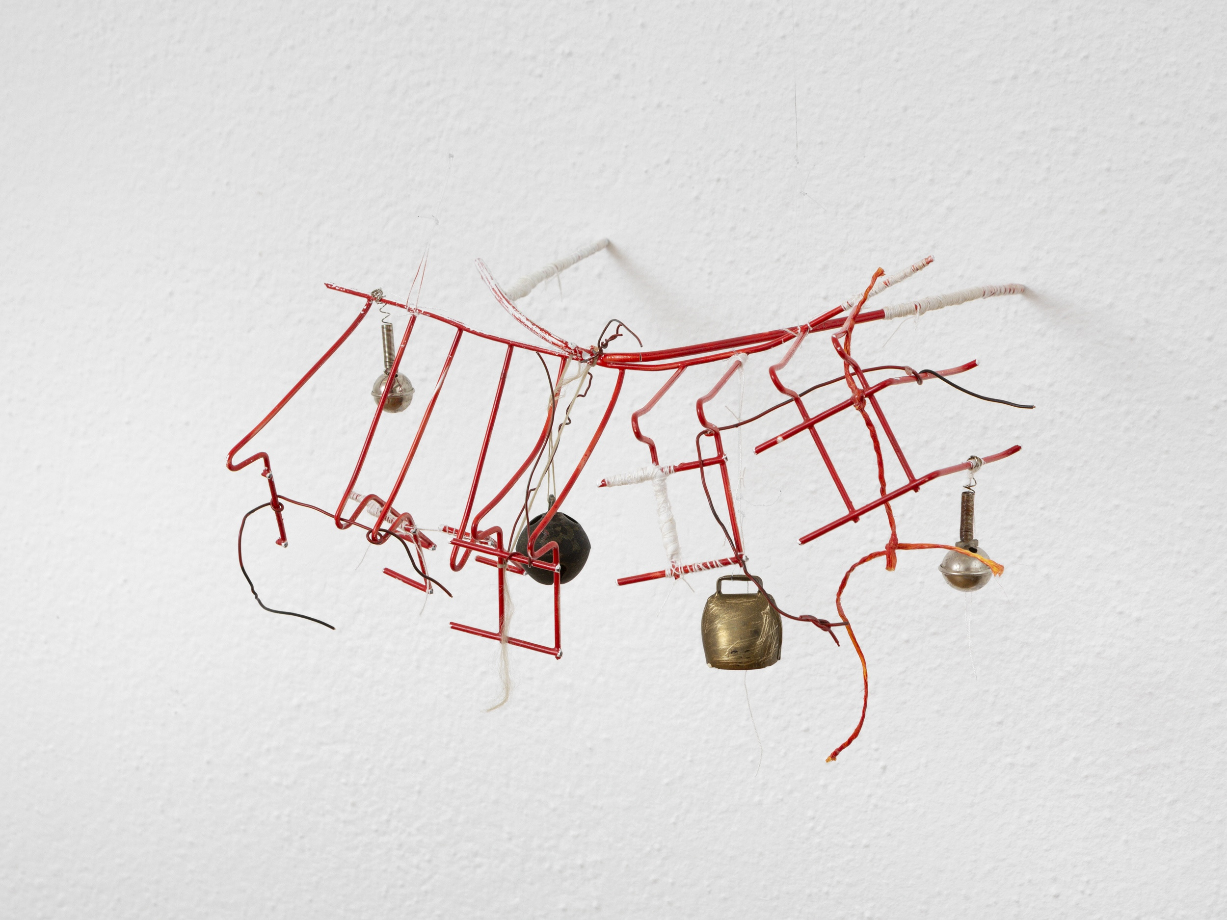 Manuel Schneider "Sunken Ship Within The Eye, 2024." Plate dryer, spray paint, bells, thread, wire fishing line, 25 x 40 x 30 cm