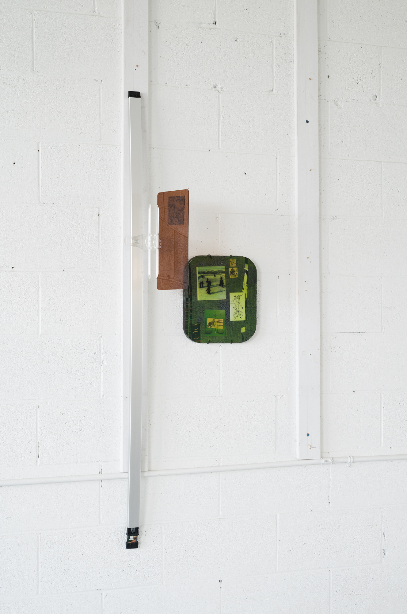 Nick Castonguay, "Prospecting with a Geiger Counter", 2024 truck bed cover crossmember, clip-on sun visor, gypsum board, silicone, image transfers, collage Dimensions Variable