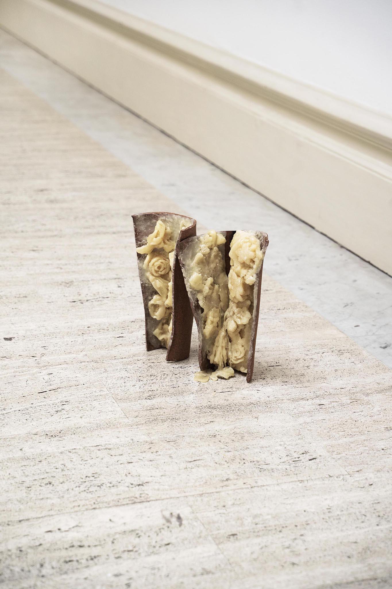 ◡◡, 2024. High-temperature ceramics fired in oxygen reduction, wax. 30 x 33 x 14 cm