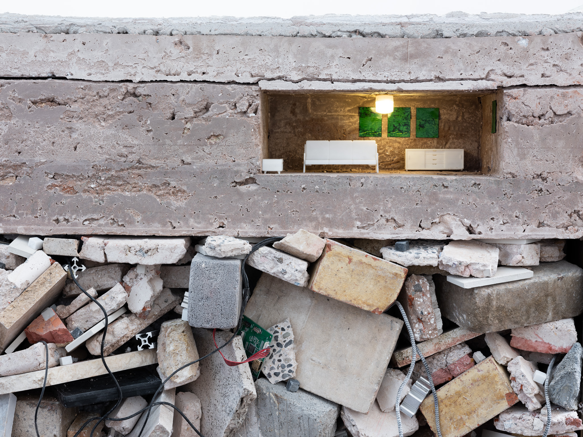 Perfect Time Compression, 2024.  Stones, recycled artworks, lime mortar, marble mosaic, aluminium v slot, cardboard, 3D printed furniture, light 100 x 100 x 60cm