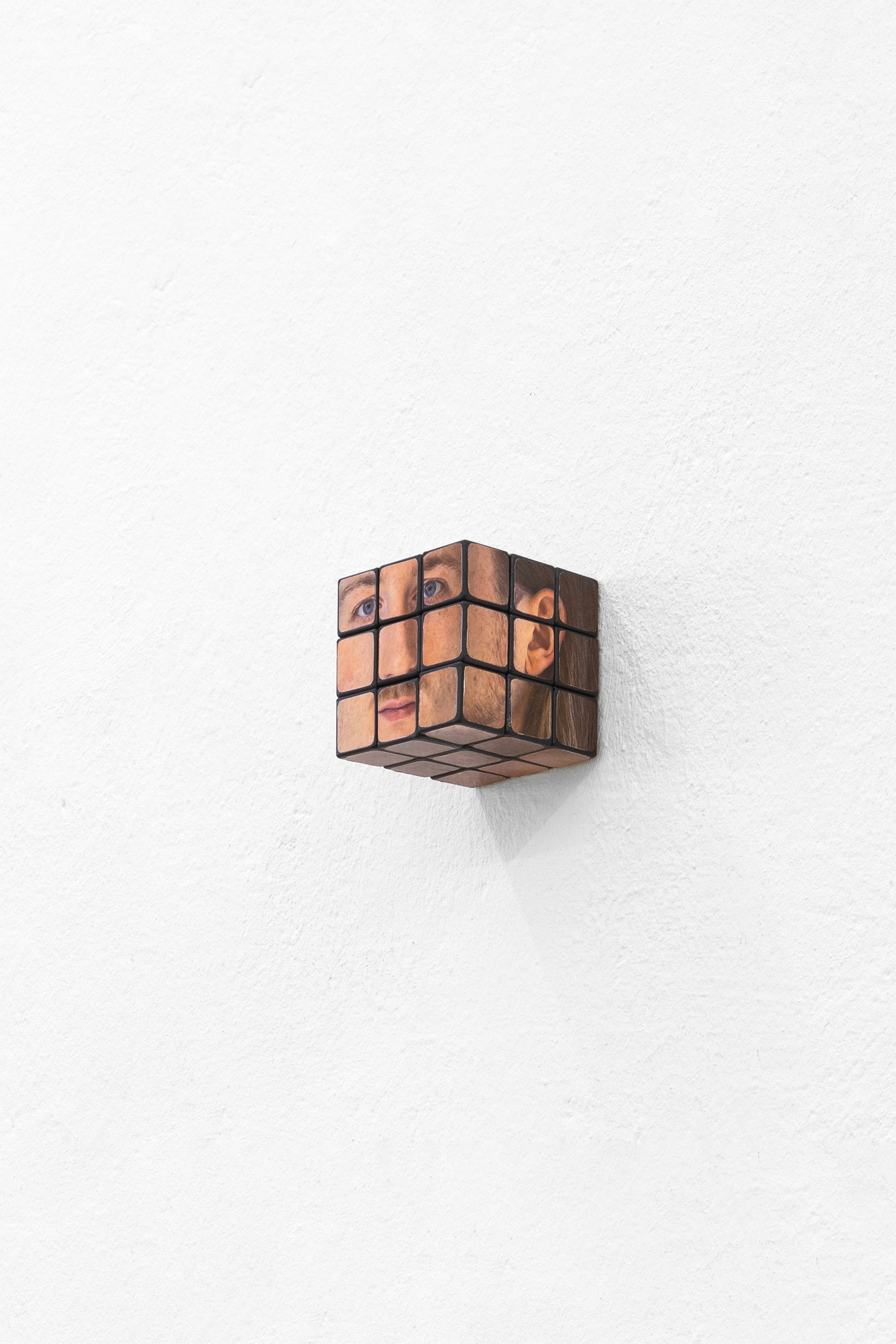 Misha Gudwin, "Gift" 2024 Rubik's cube, paper print.
