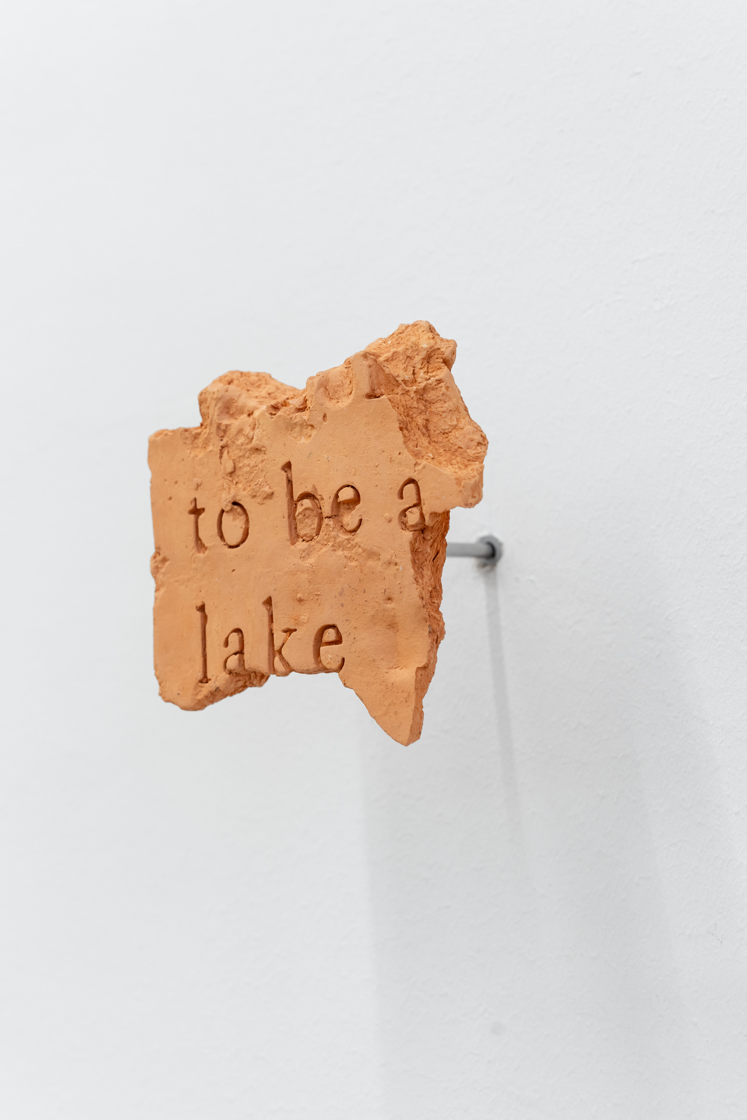 Lennart Lahuis, "MURMUR #41/ To be a lake", 2018 - 2024, fired clay and stainless steal, 14 x 20 cm.