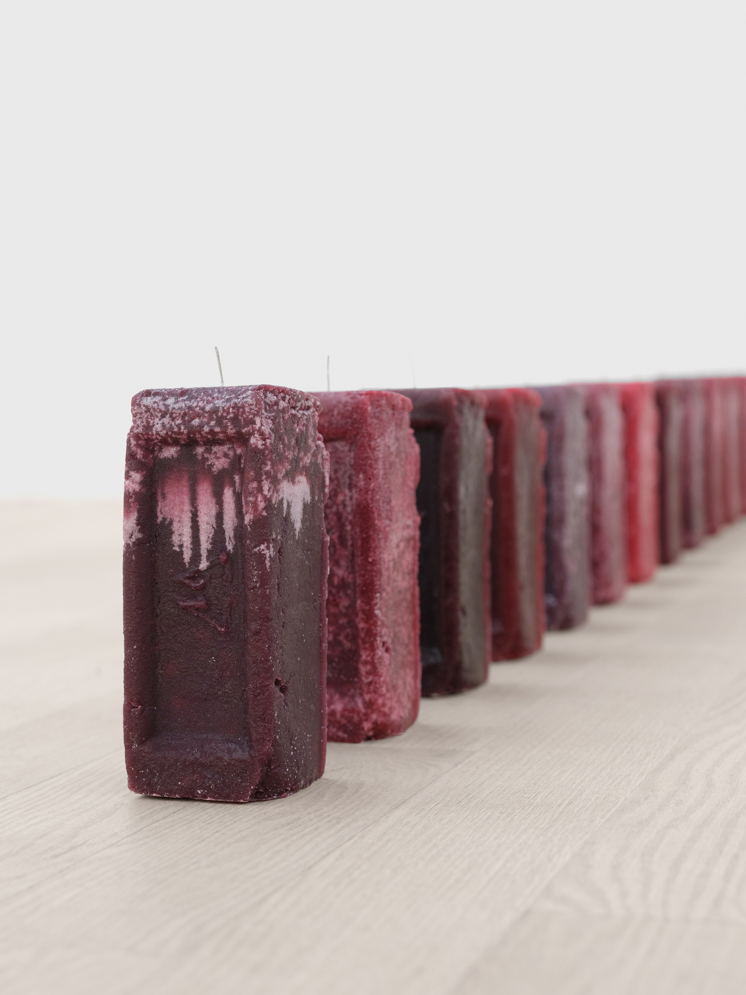 Tahir Karmali, Untitled (Brick Candles), 2024, Beeswax, wax pigment, scented oils, and cotton wick, 8 x 3 x 3.25 inches / 20.3 x 7.6 x 8.25 cm