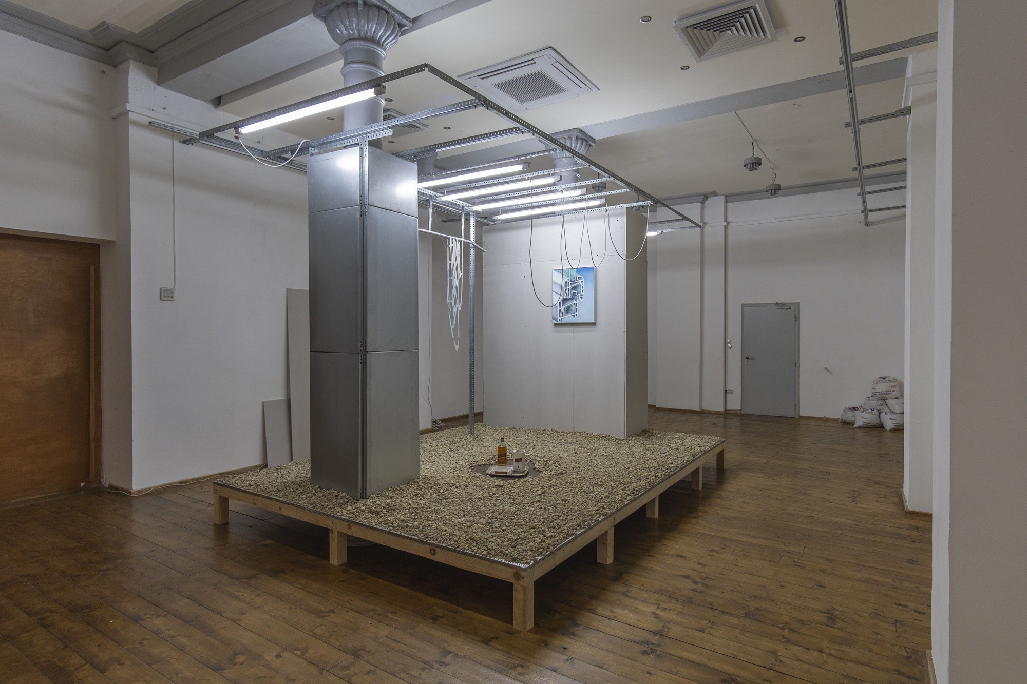 the last good drink (2024) installation, chip board wood, stainless steal bars, luminescent lights, stales steal cladding and paster board, and electrical cable. 400cm x 380cm x 270cm