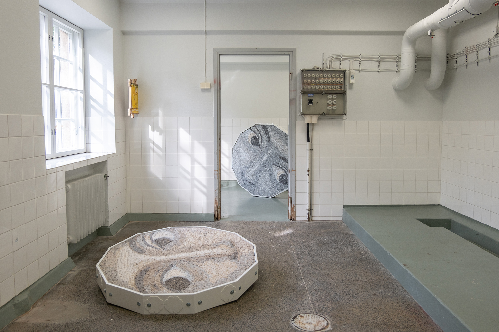On the floor: "Lost in the field of wild daisies", marble, bolts, painted mdf, 2024 / Riikka Anttonen On the wall: 45°C, 50x72 cm, oil on canvas, wood, 2024 / Kerttu Saali